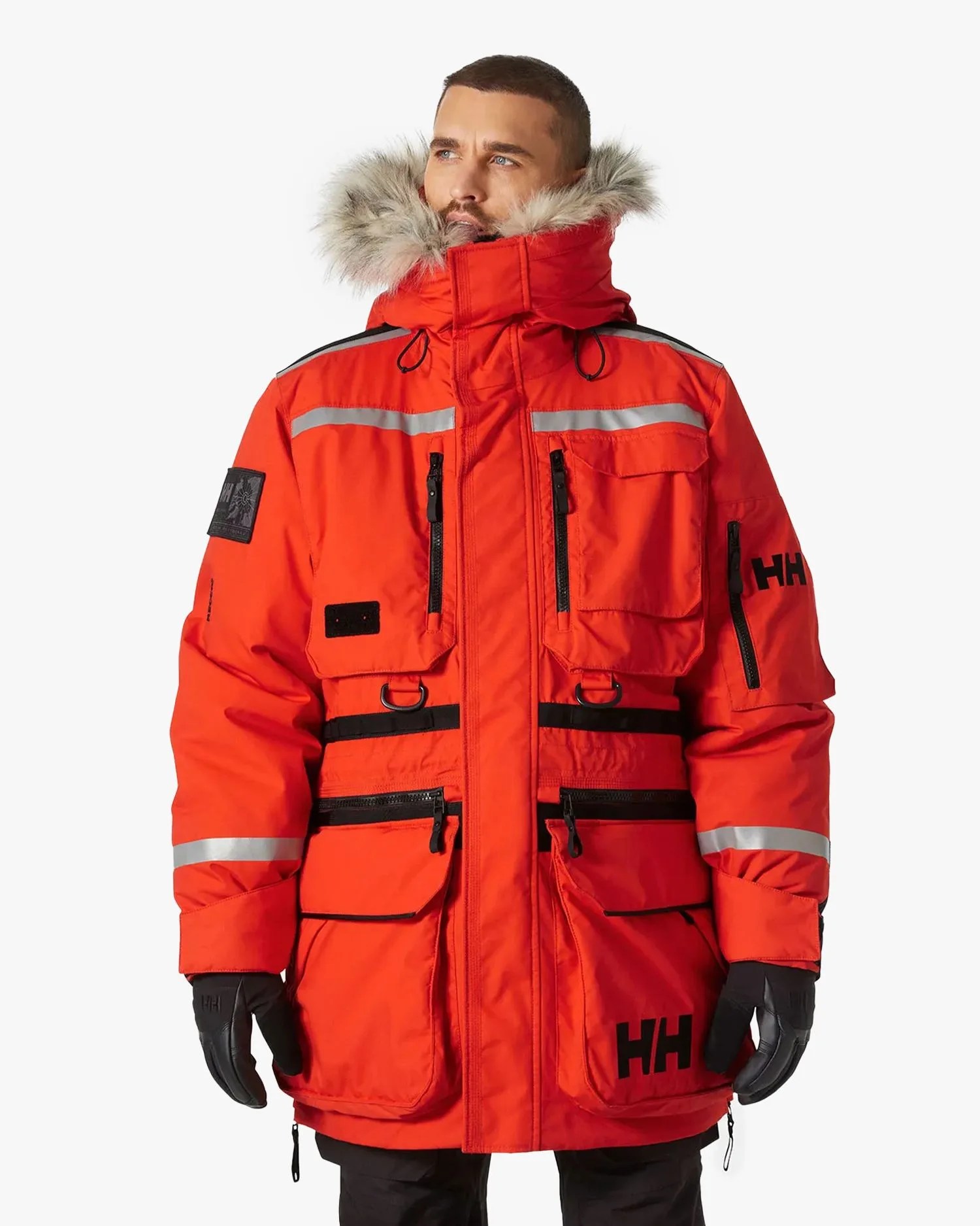 a person wearing a red men’s arctic patrol modular parka coat