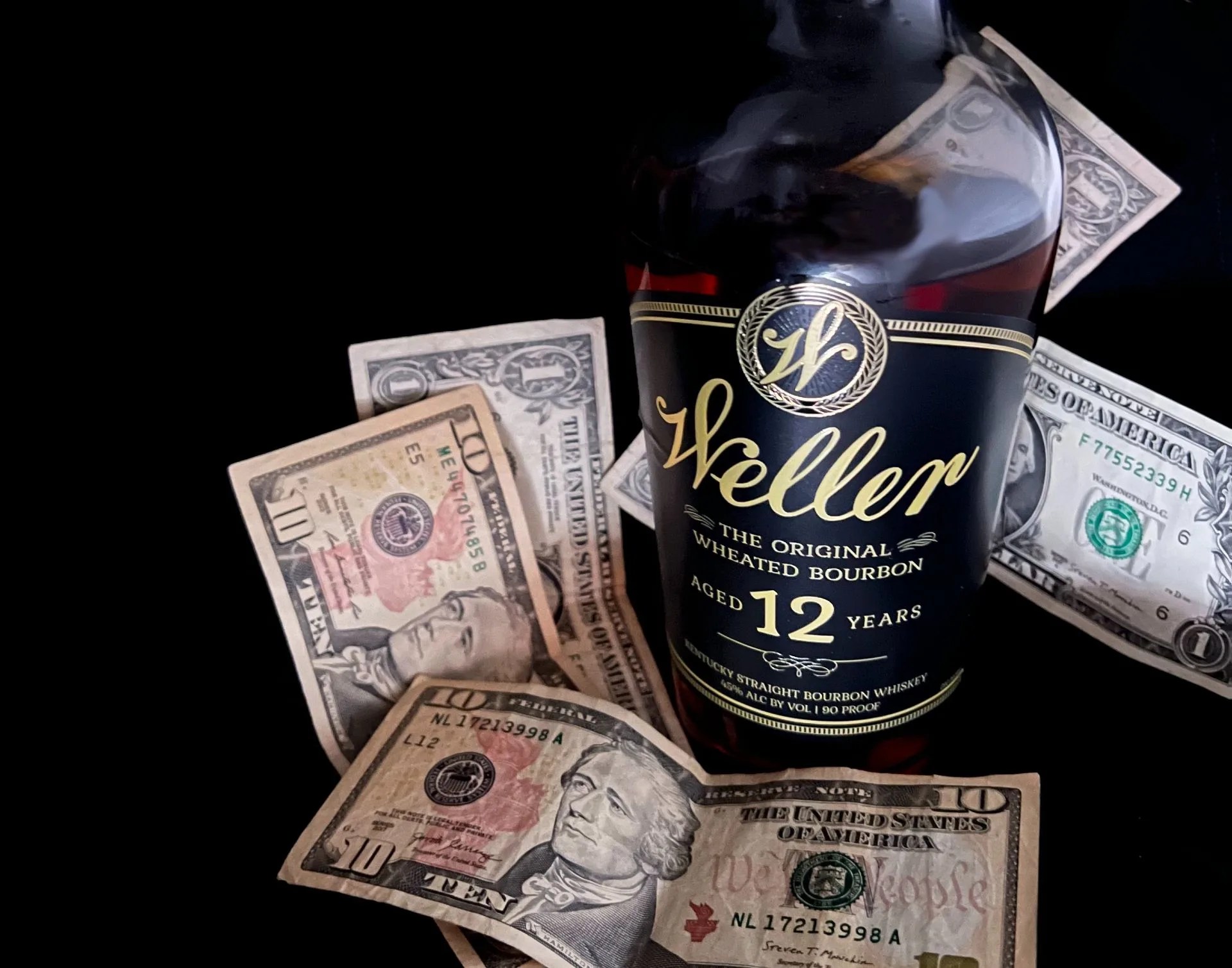 bottle of bourbon with money