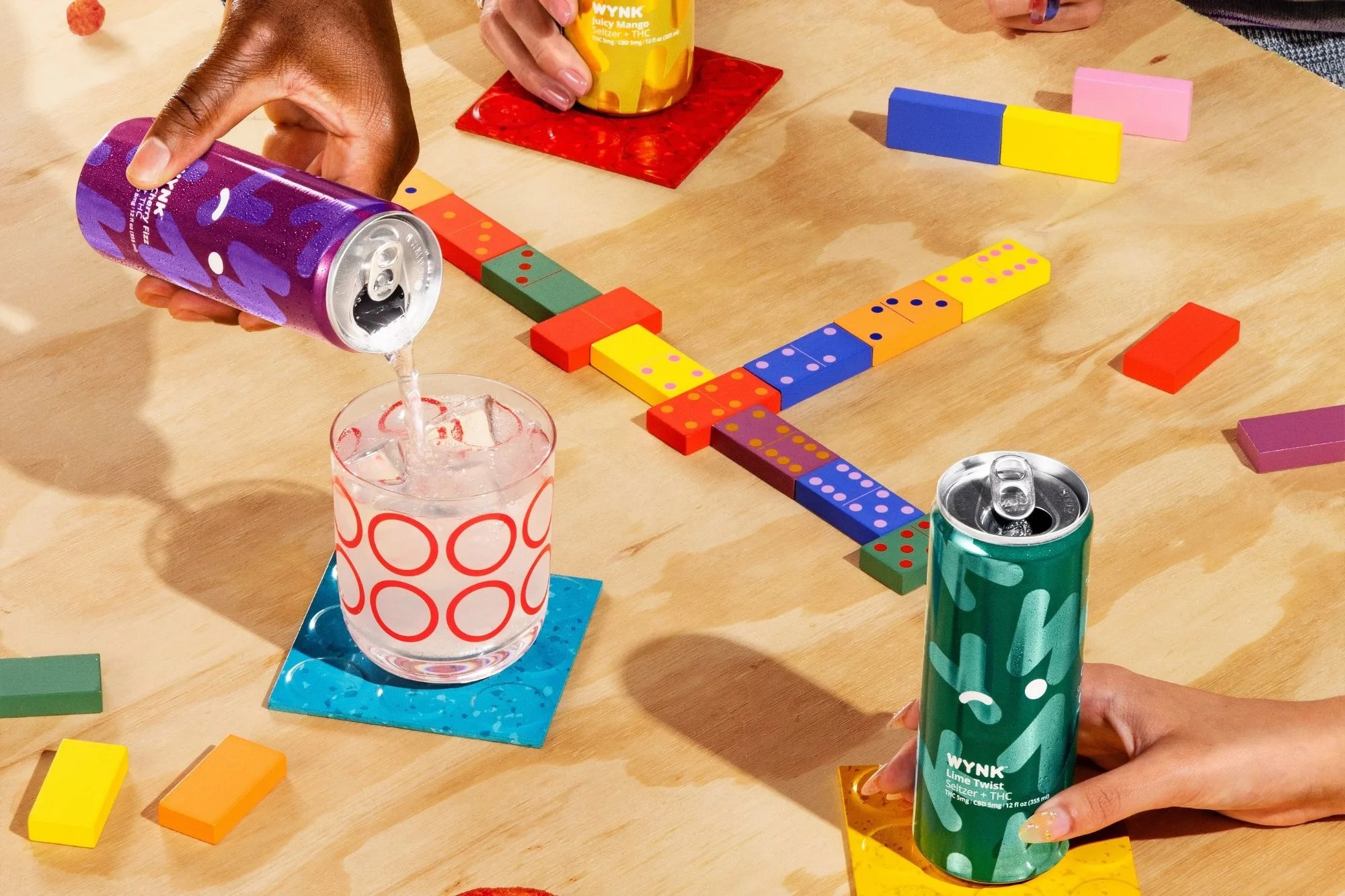 a person holding a wynk drinks