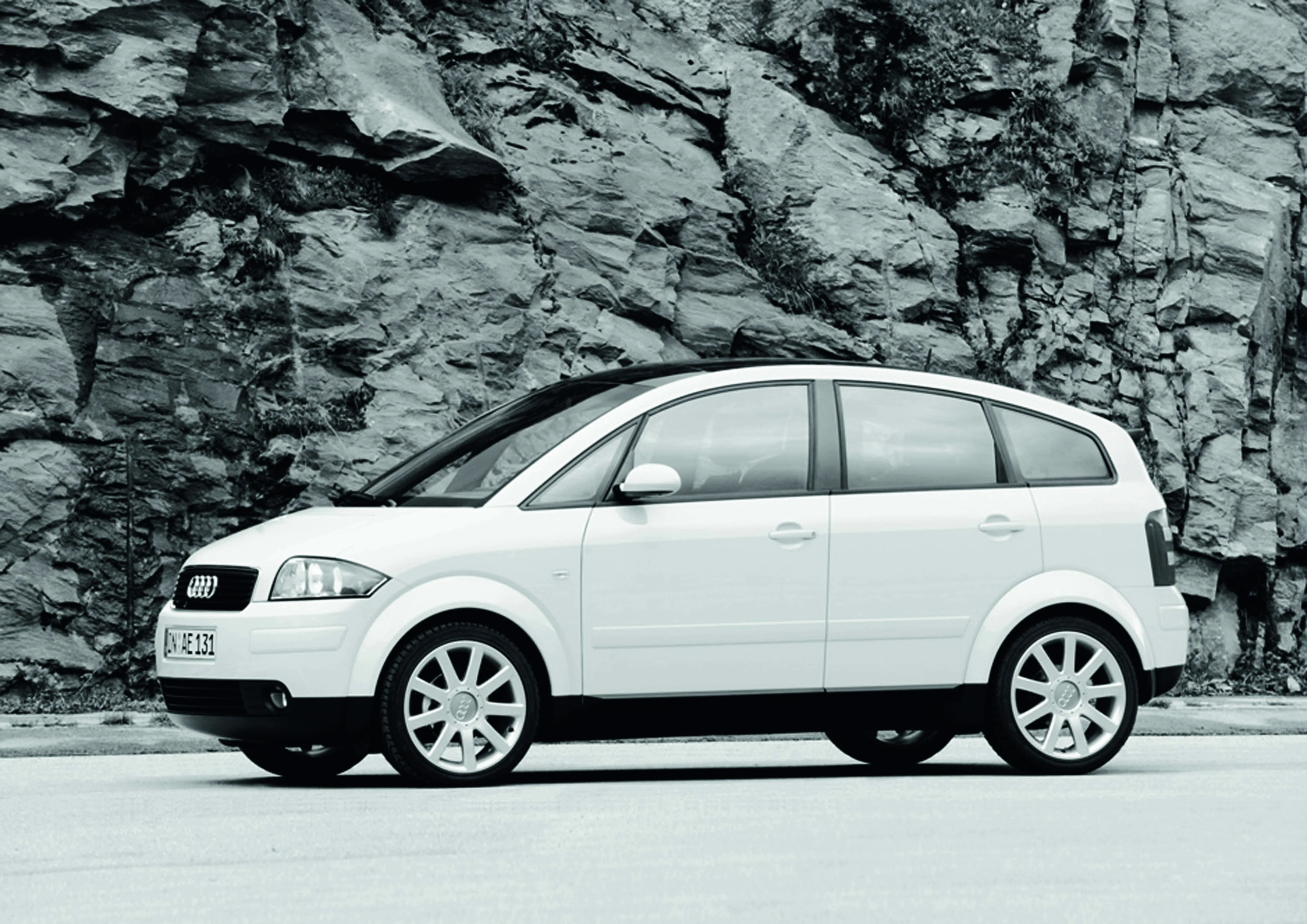 Audi A2 parked in front of rocks