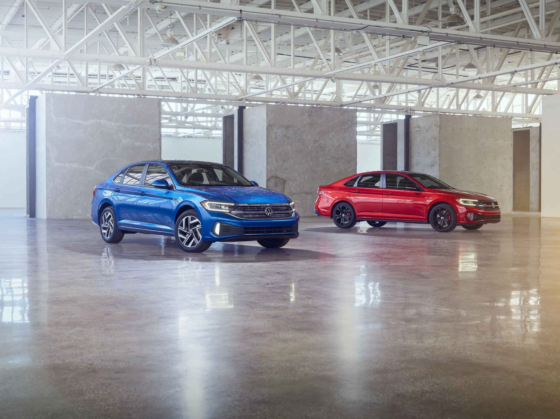 2024 volkswagen jetta in blue and jetta gli in red in an art gallery