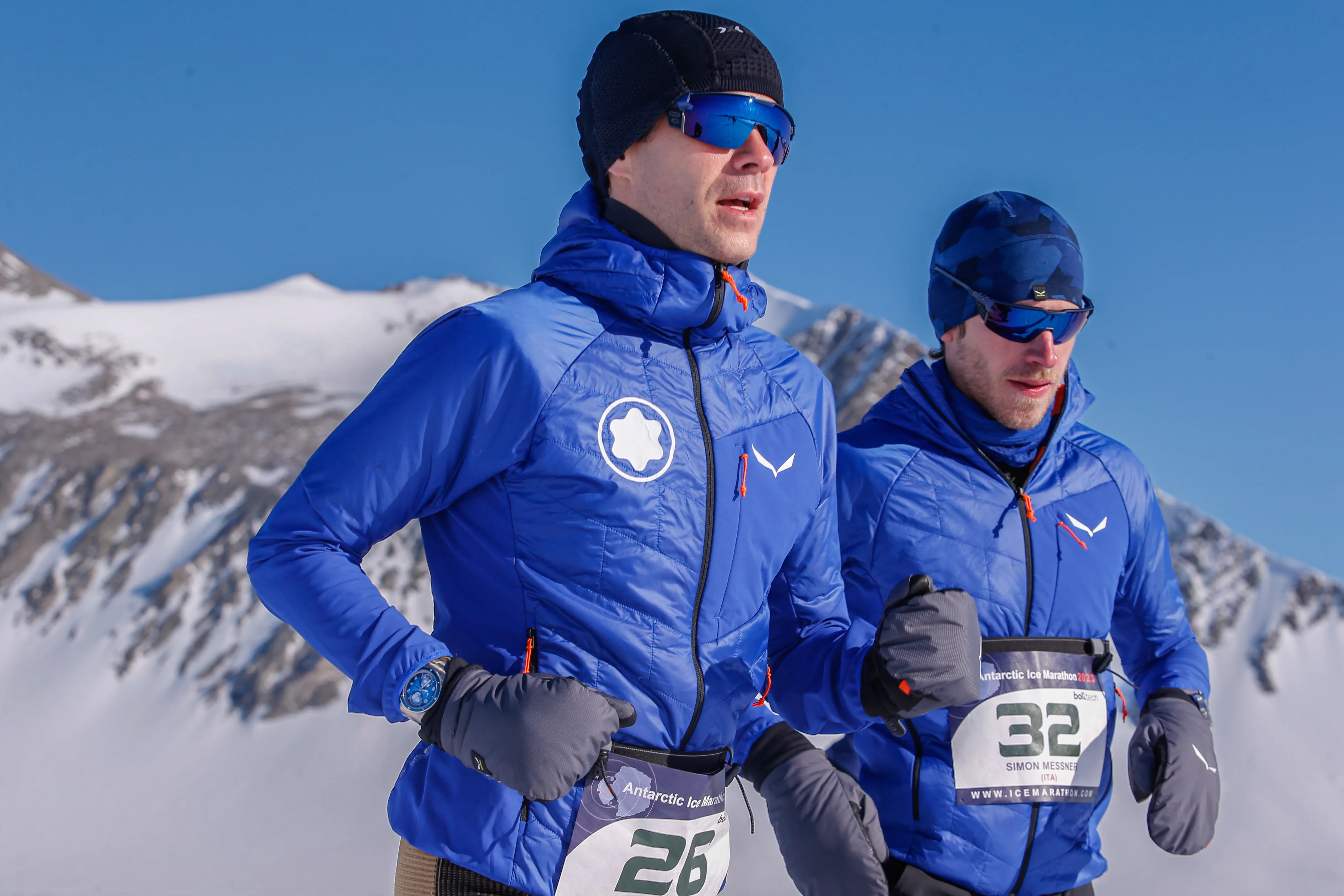Two men running in Antarctica