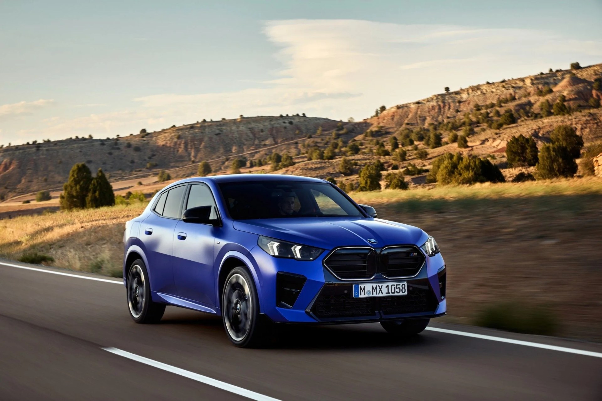 a blue car driving on a road
