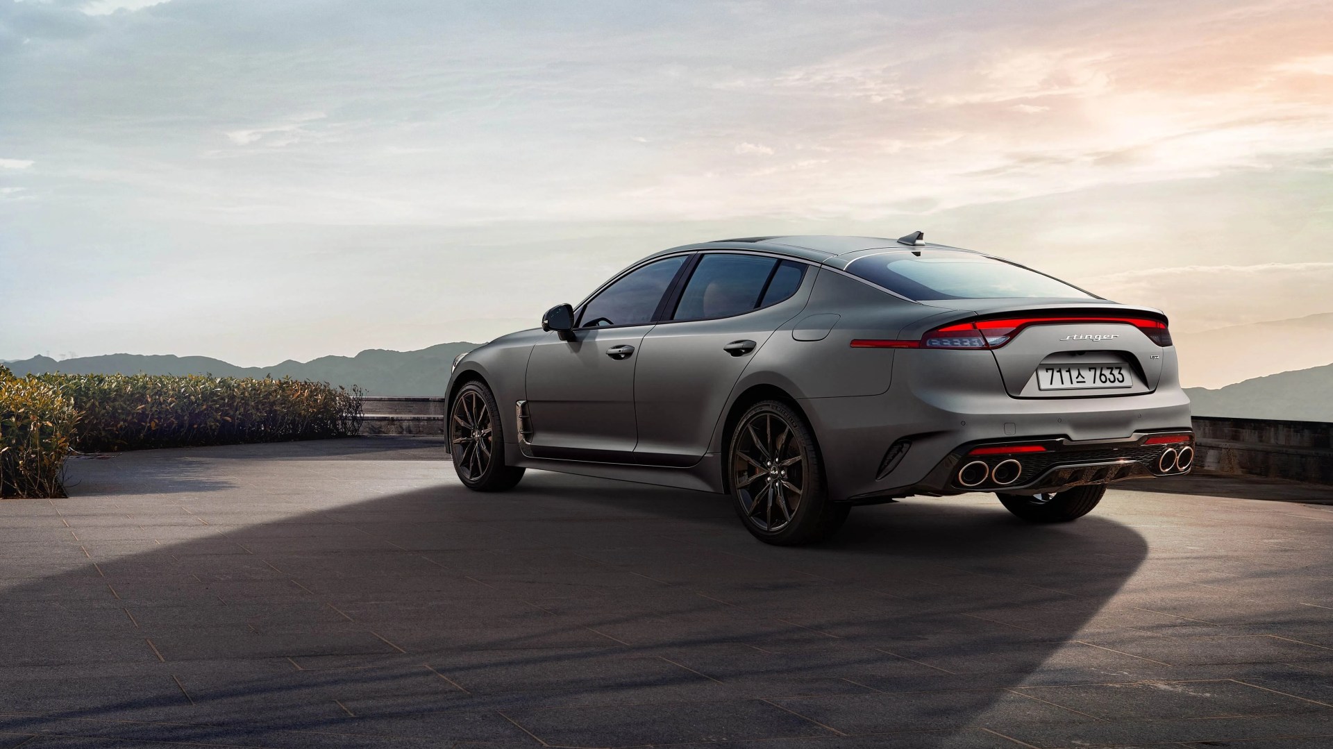 Kia Stinger parked with mountains in background