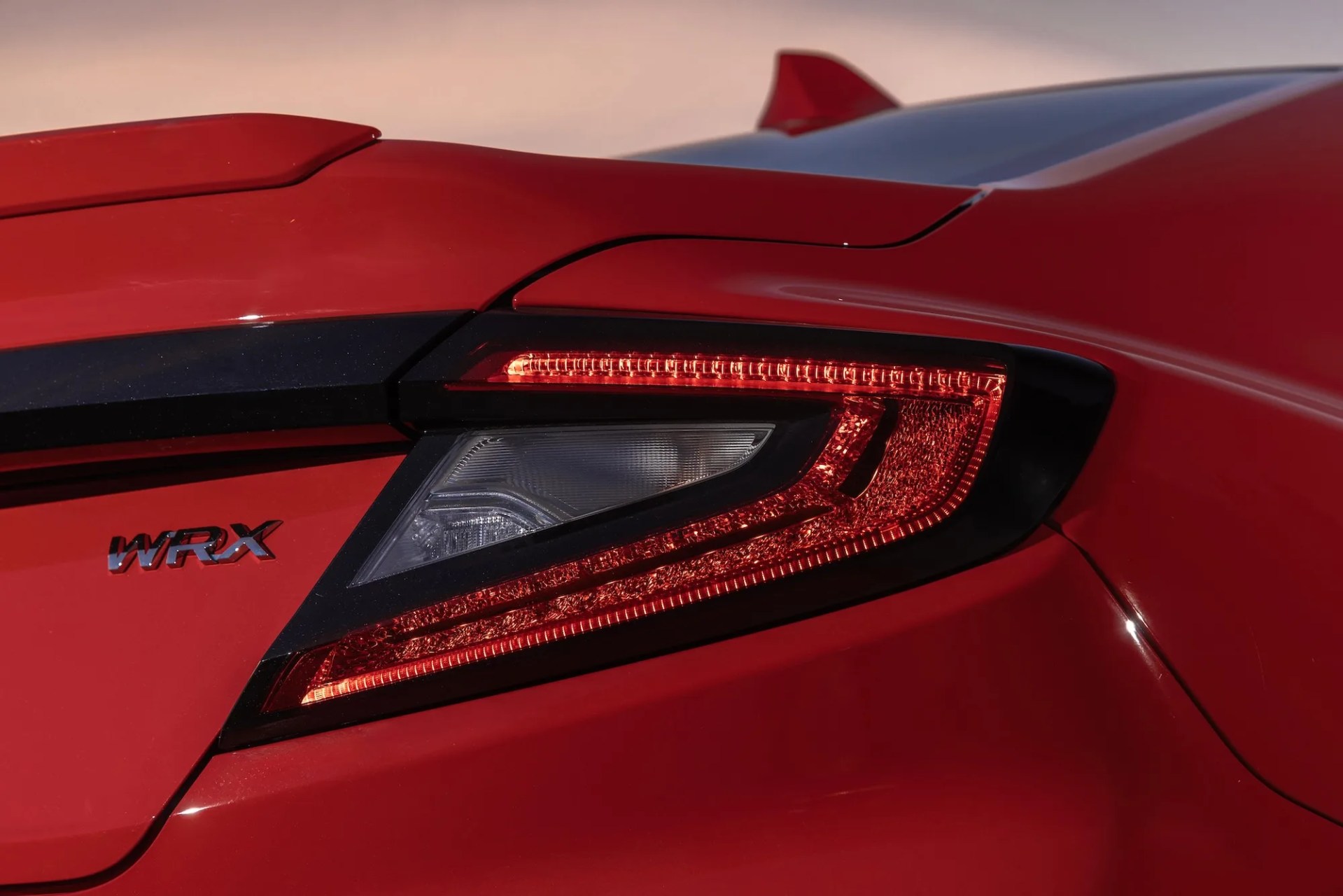 close-up of red subaru WRX rear right taillight and badge
