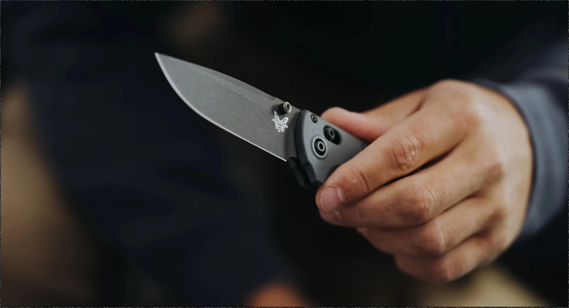 a person holding a benchmade knife