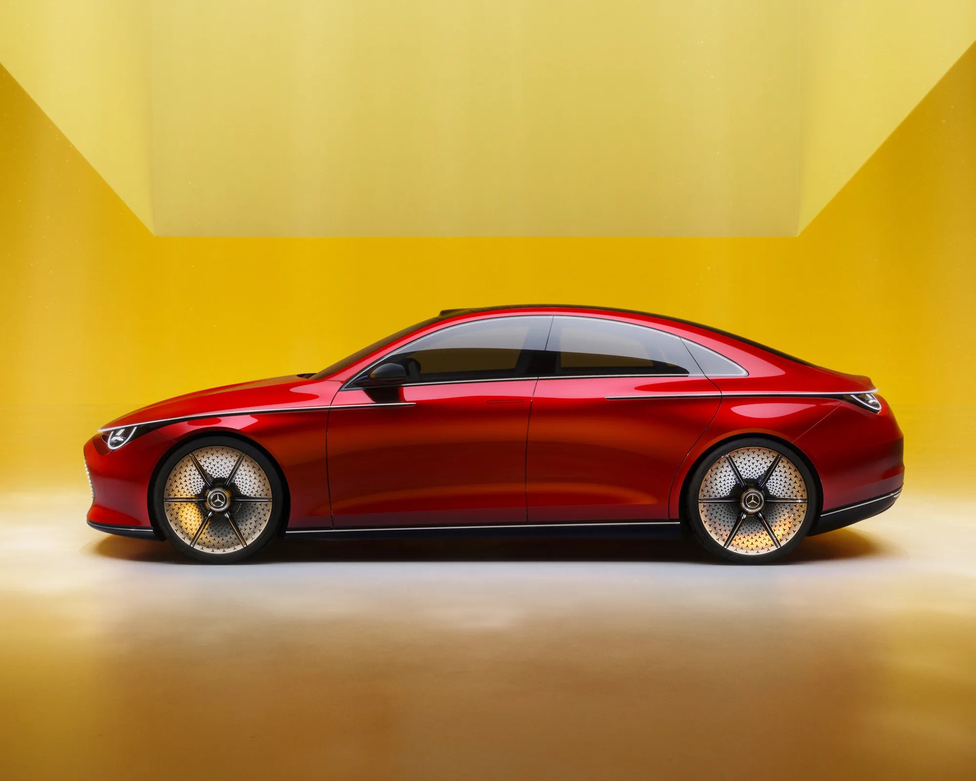a side view of the mercedes benz concept cla class in front of a yellow wall