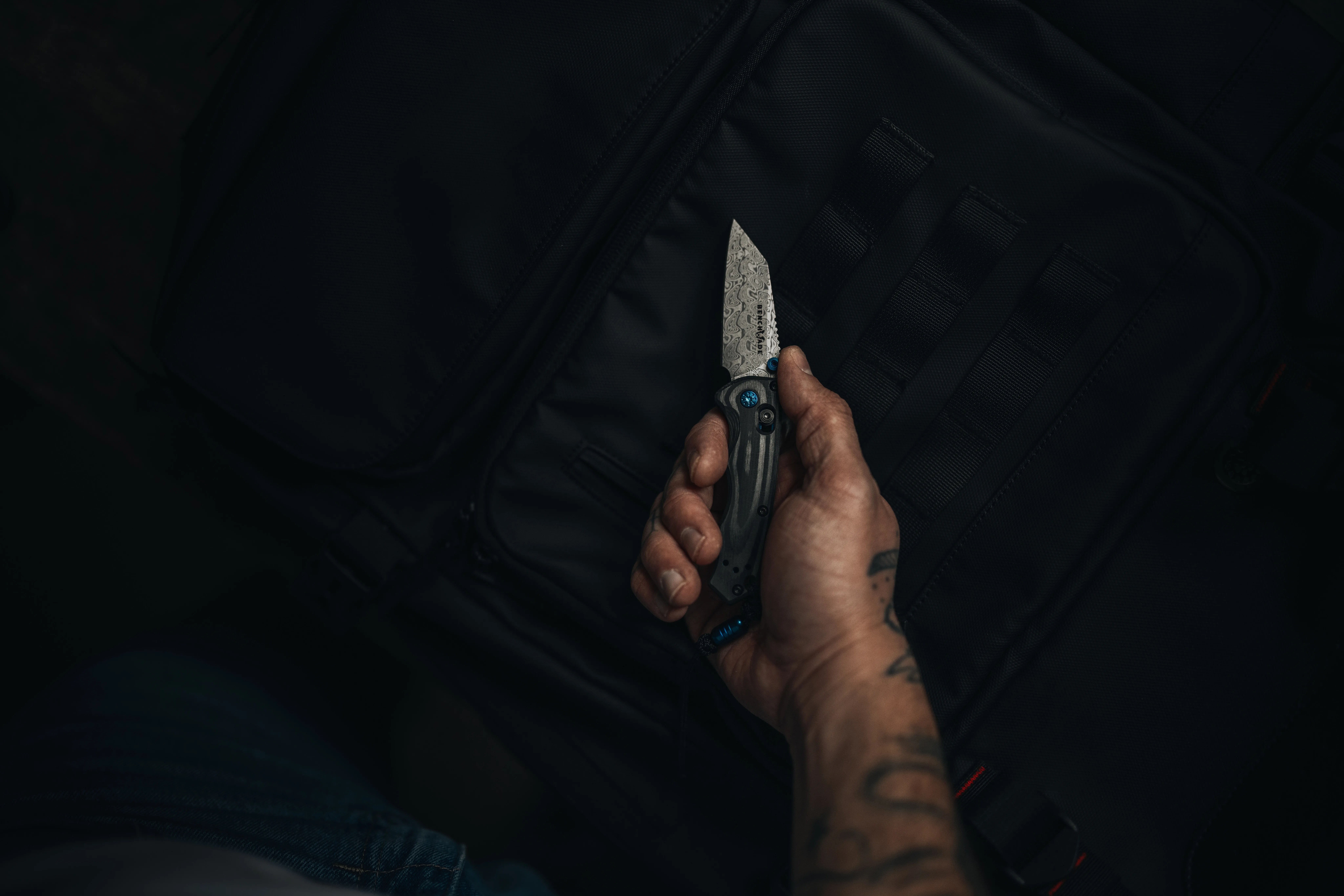 man's hand holding benchmade gold class full immunity knife