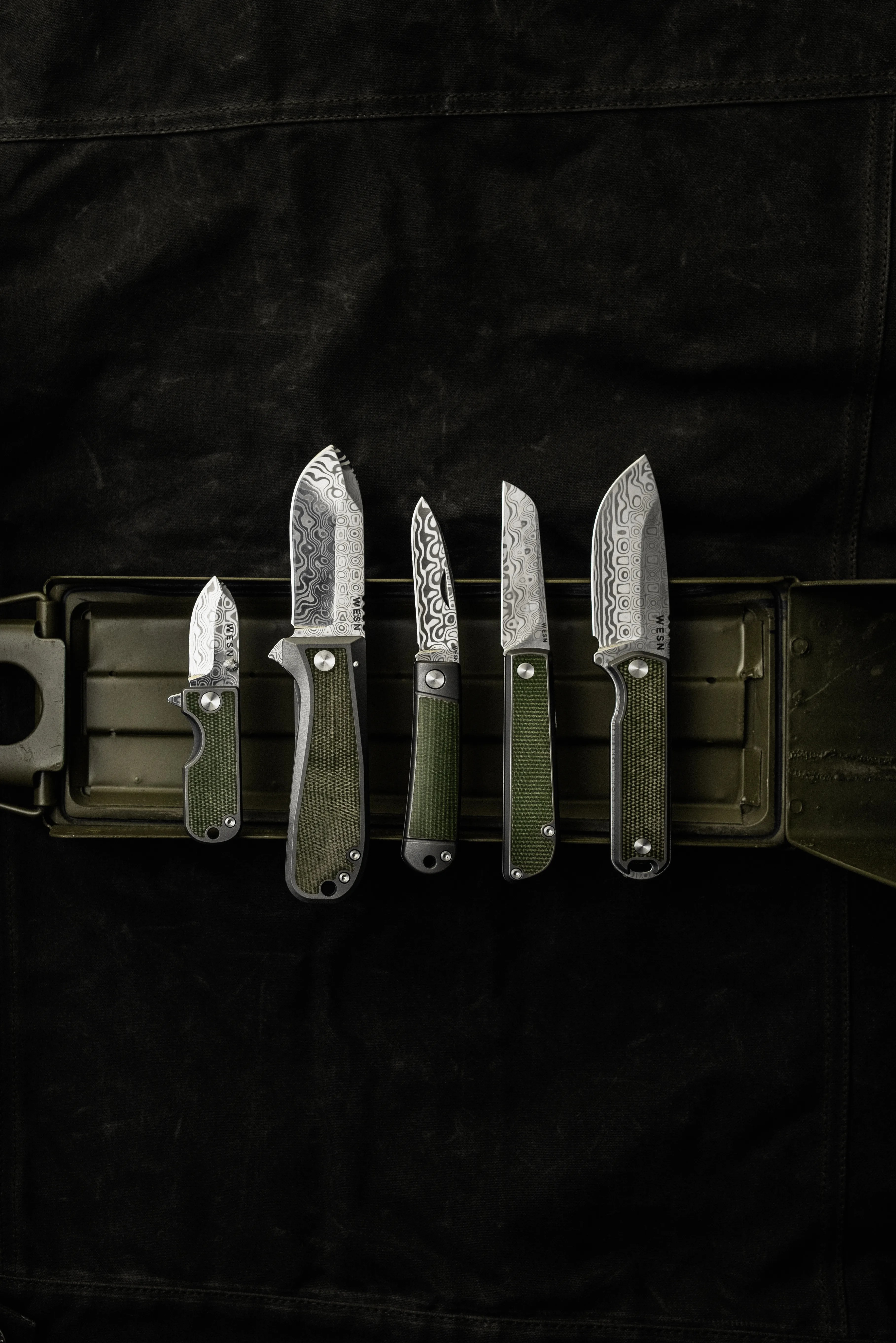 wesn founder's line knives on a green and black background