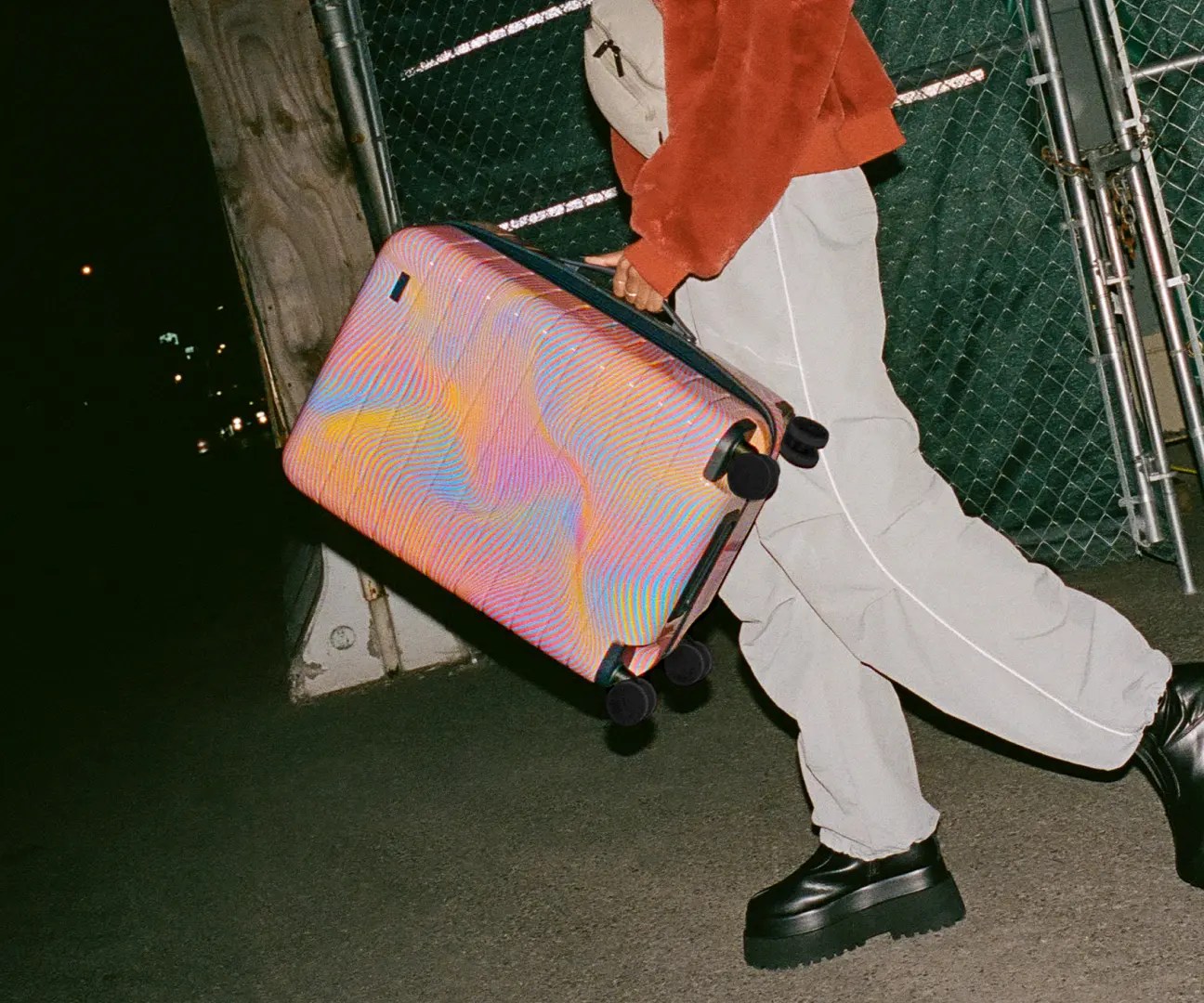 woman carrying away limited edition sound wave suitcase