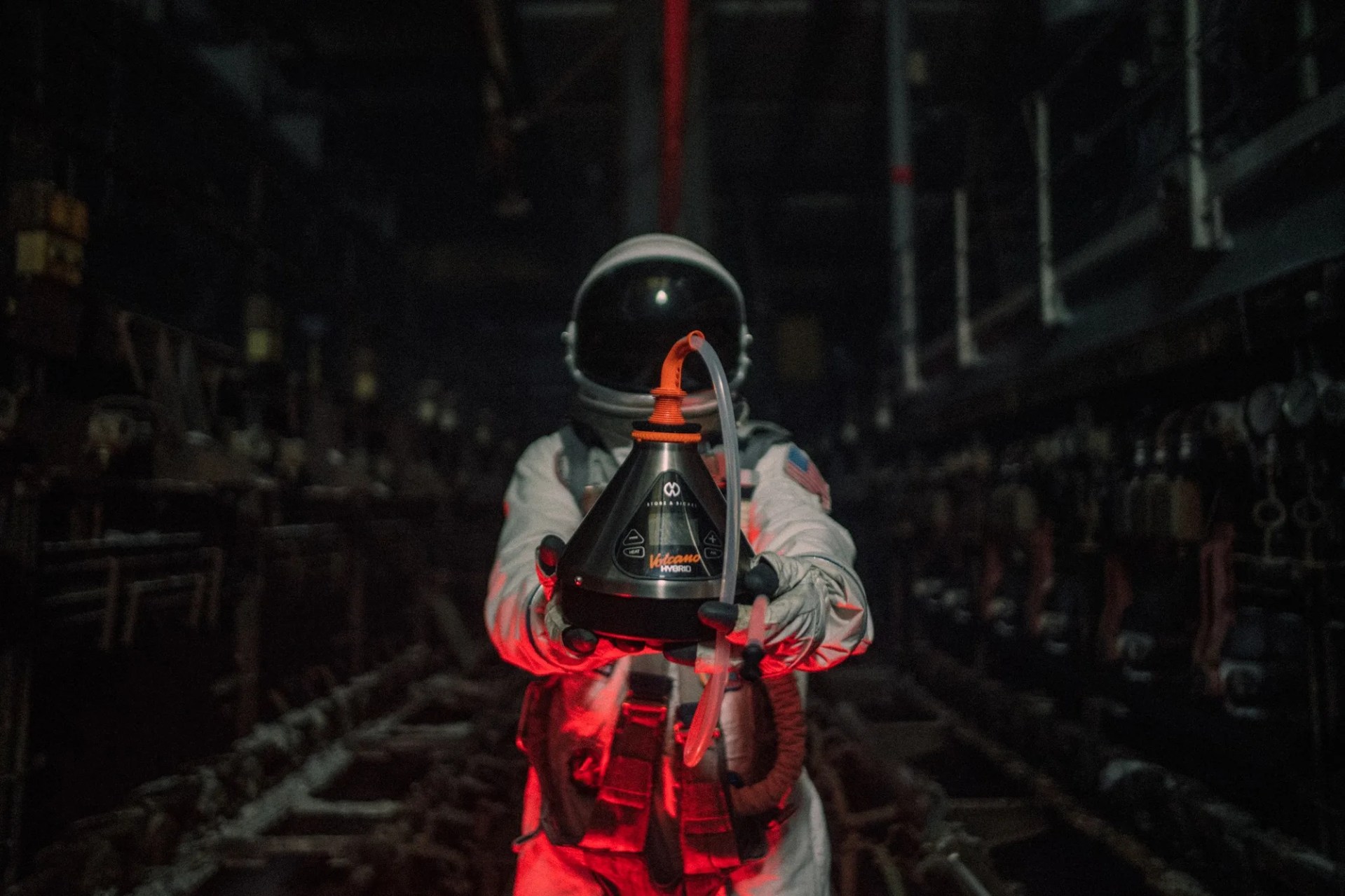 An astronaut holding a Storz & Bickel Volcano weed vape
