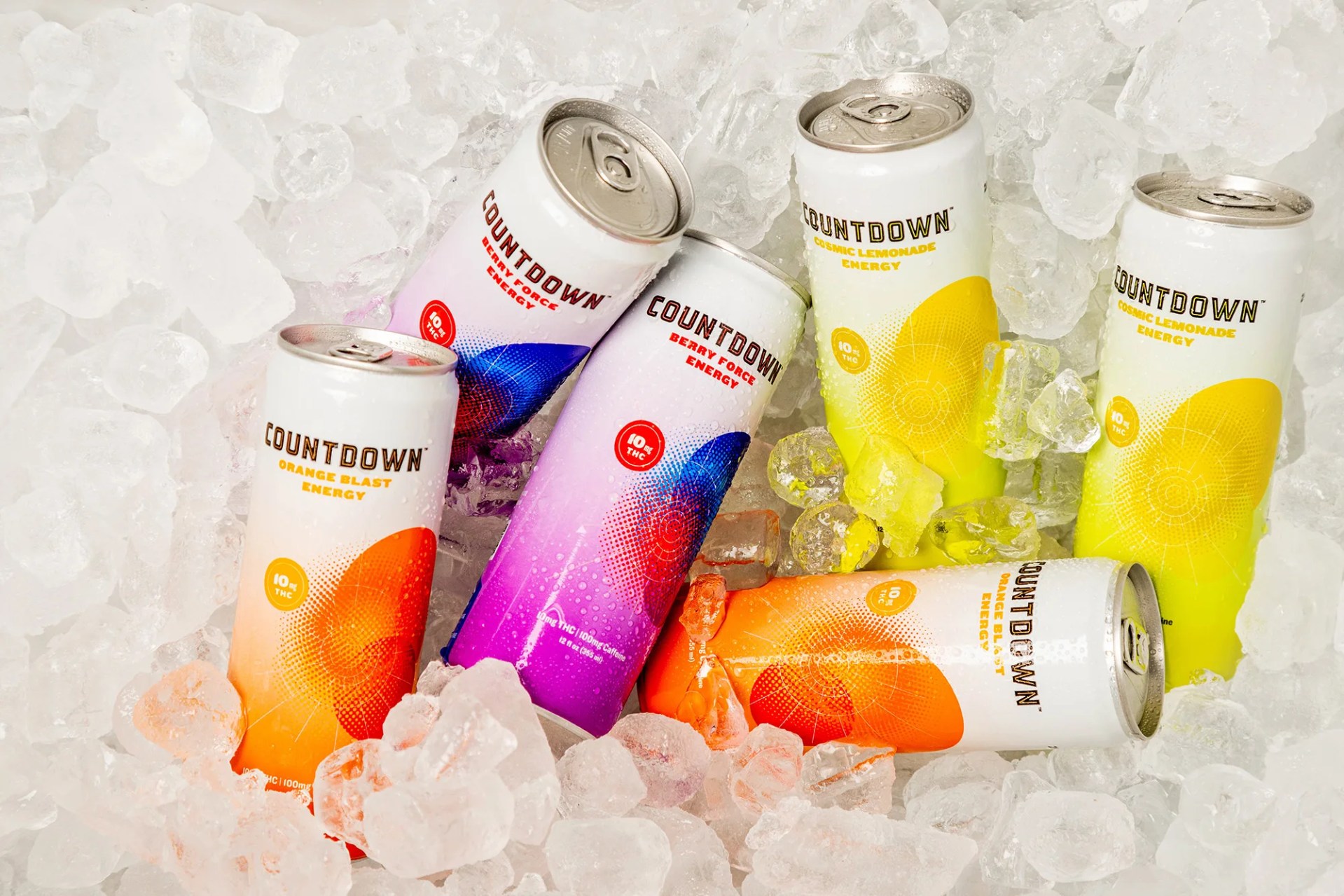 Six cans of countdown energy drink on top of ice cubes