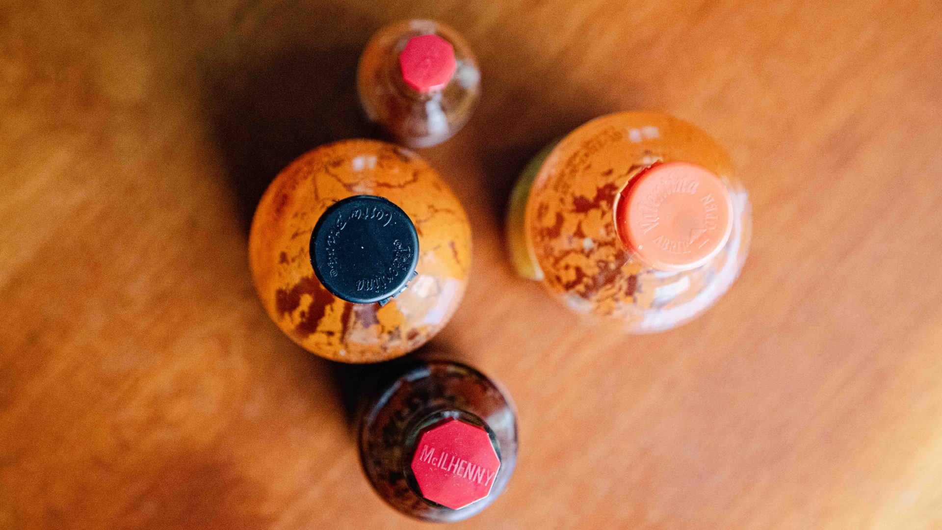 hot sauce bottles on a wooden table