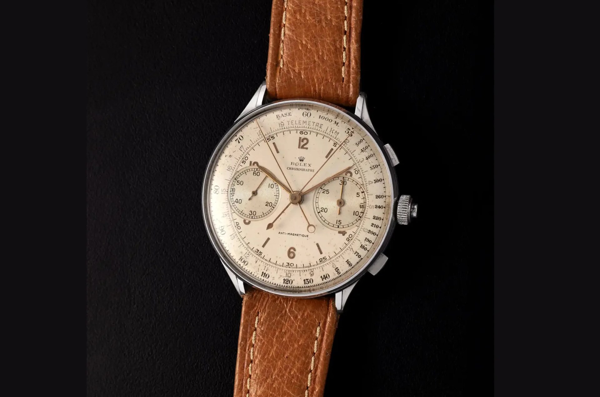 vintage rolex watch against a black background