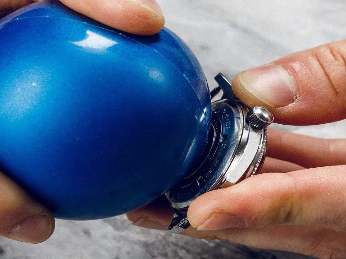 Watch friction ball tool being used to unscrew the casebook of a mechanical watch