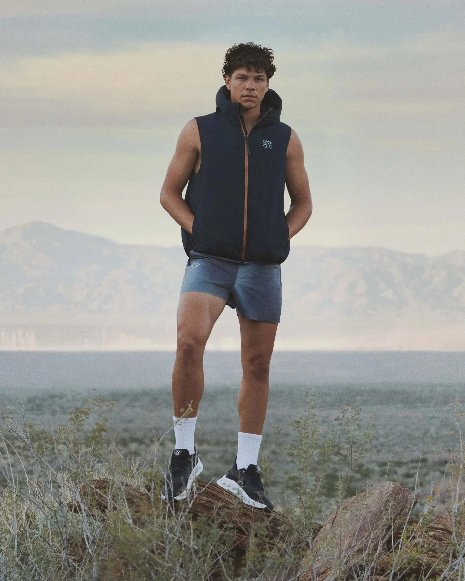 man standing on a rock in the desert