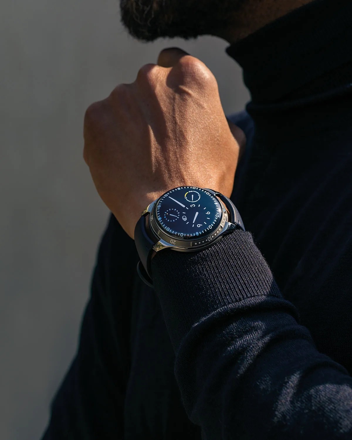 watch on wrist of man with sweater