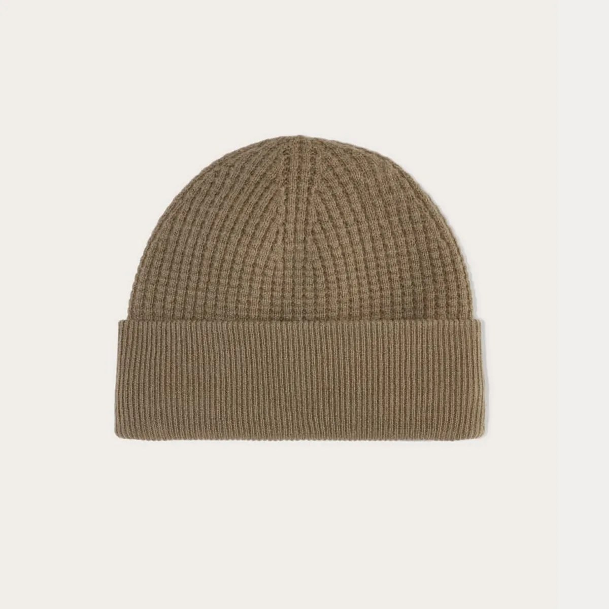 Brown ribbed knit beanie hat with folded cuff on a white background.