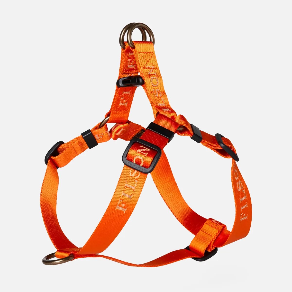 Bright orange adjustable dog harness with black plastic buckles and metal rings.