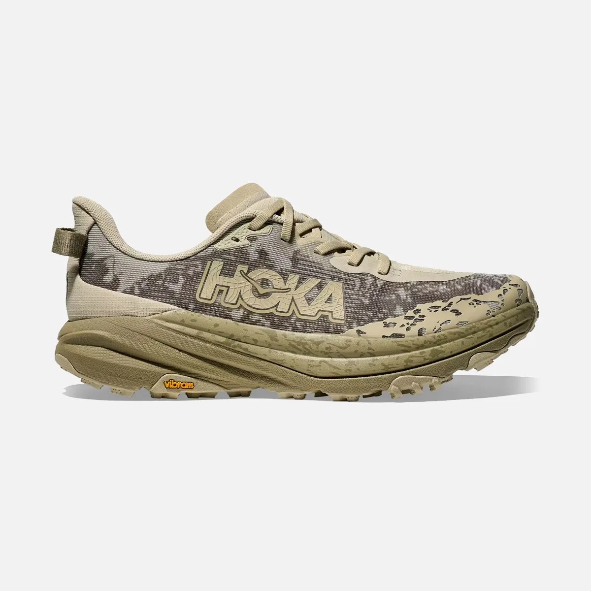 Beige and brown Hoka running shoe with Vibram sole and patterned upper.