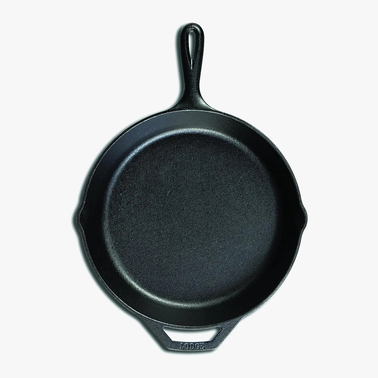 Black cast iron skillet with a long handle and a helper handle on a white background.