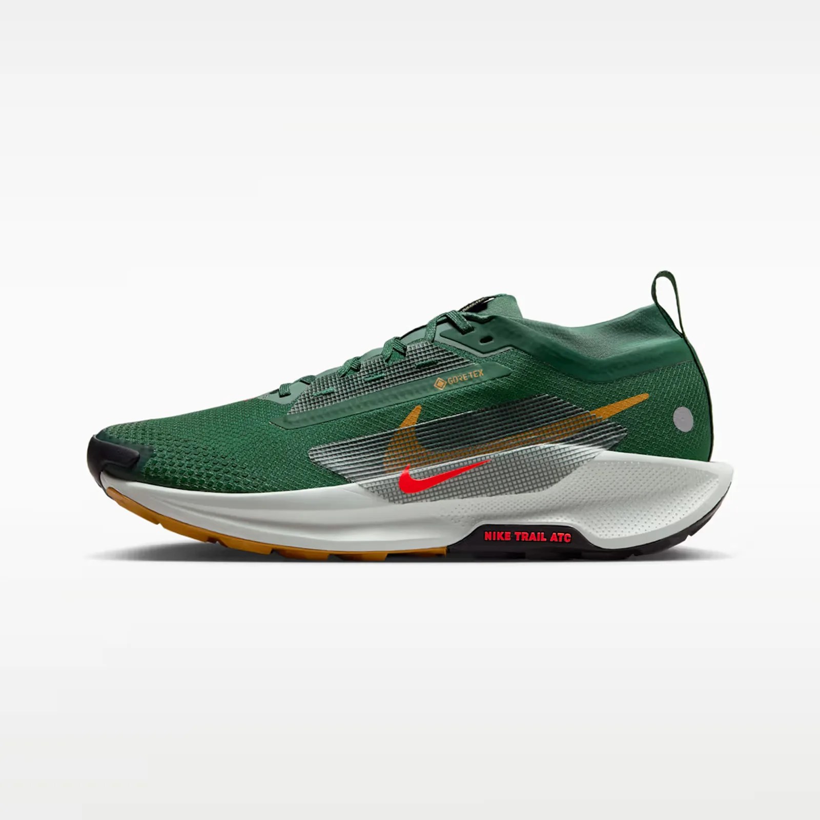 Green Nike trail running shoe with white midsole, orange and red swoosh logos, and black and orange outsole.