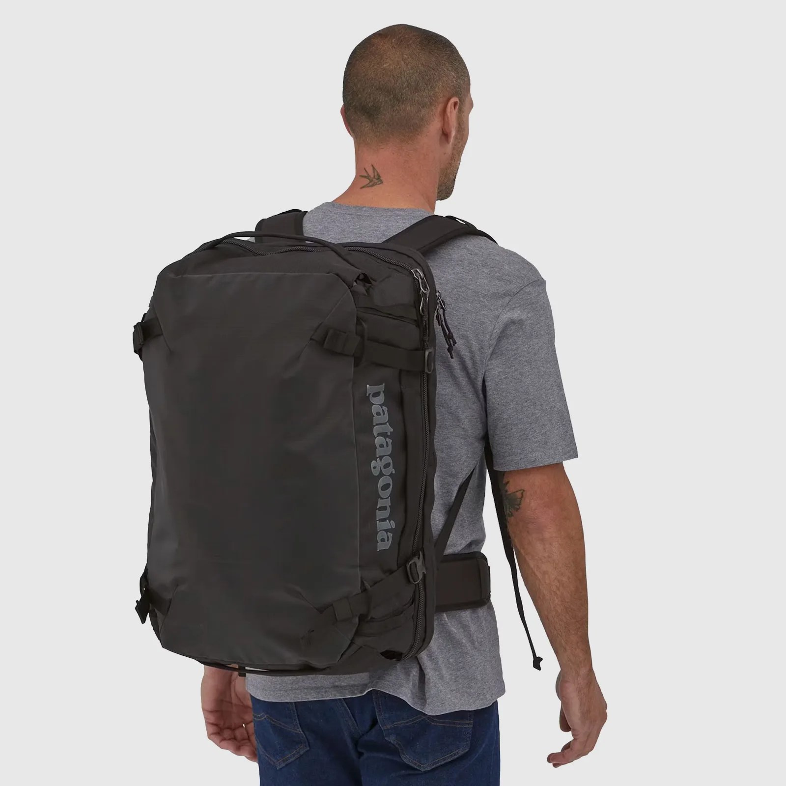 A man wearing a Patagonia Black Hole MLC Travel Backpack - 45L showing his back