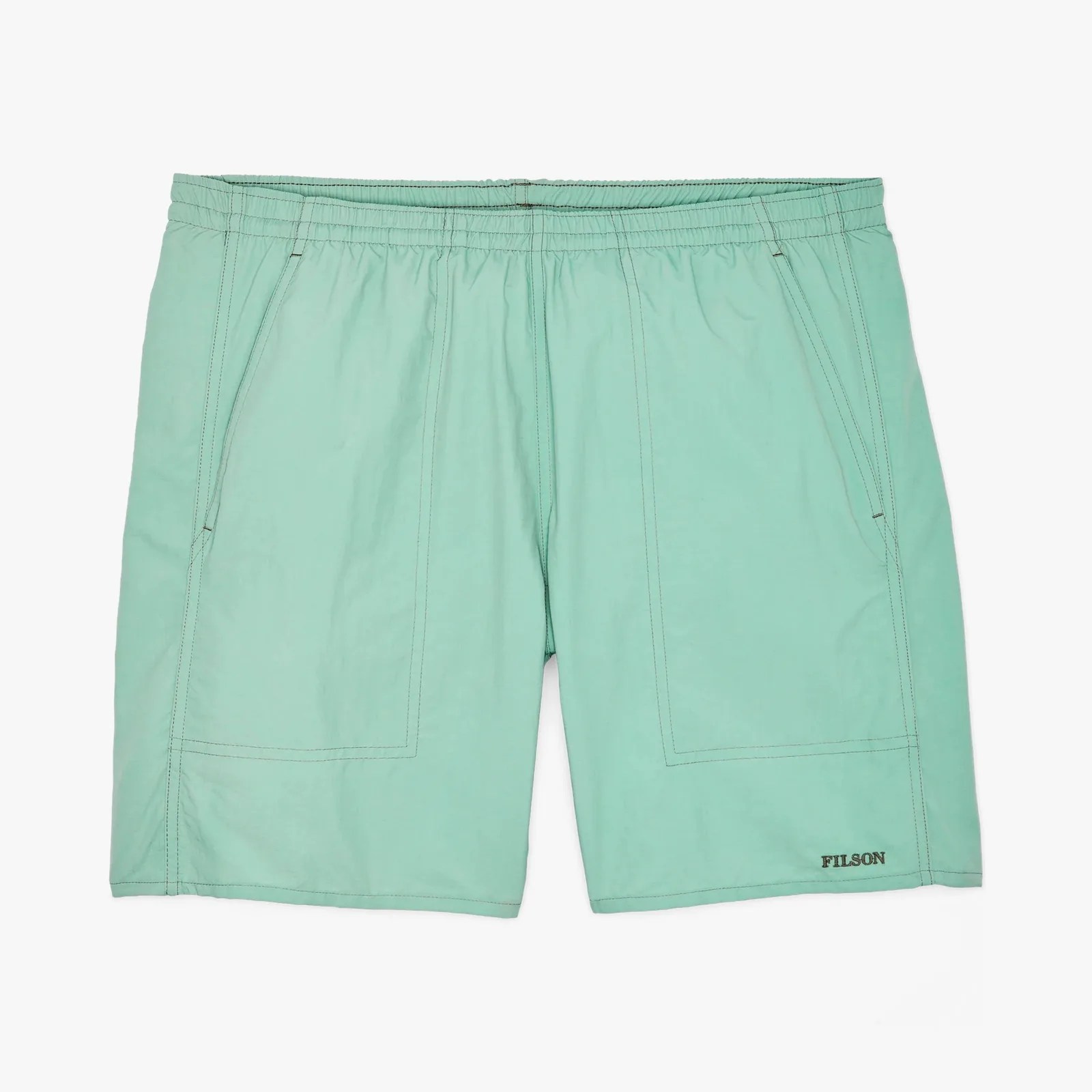 Light green shorts with elastic waistband and front pockets, featuring "FILSON" logo near hem.