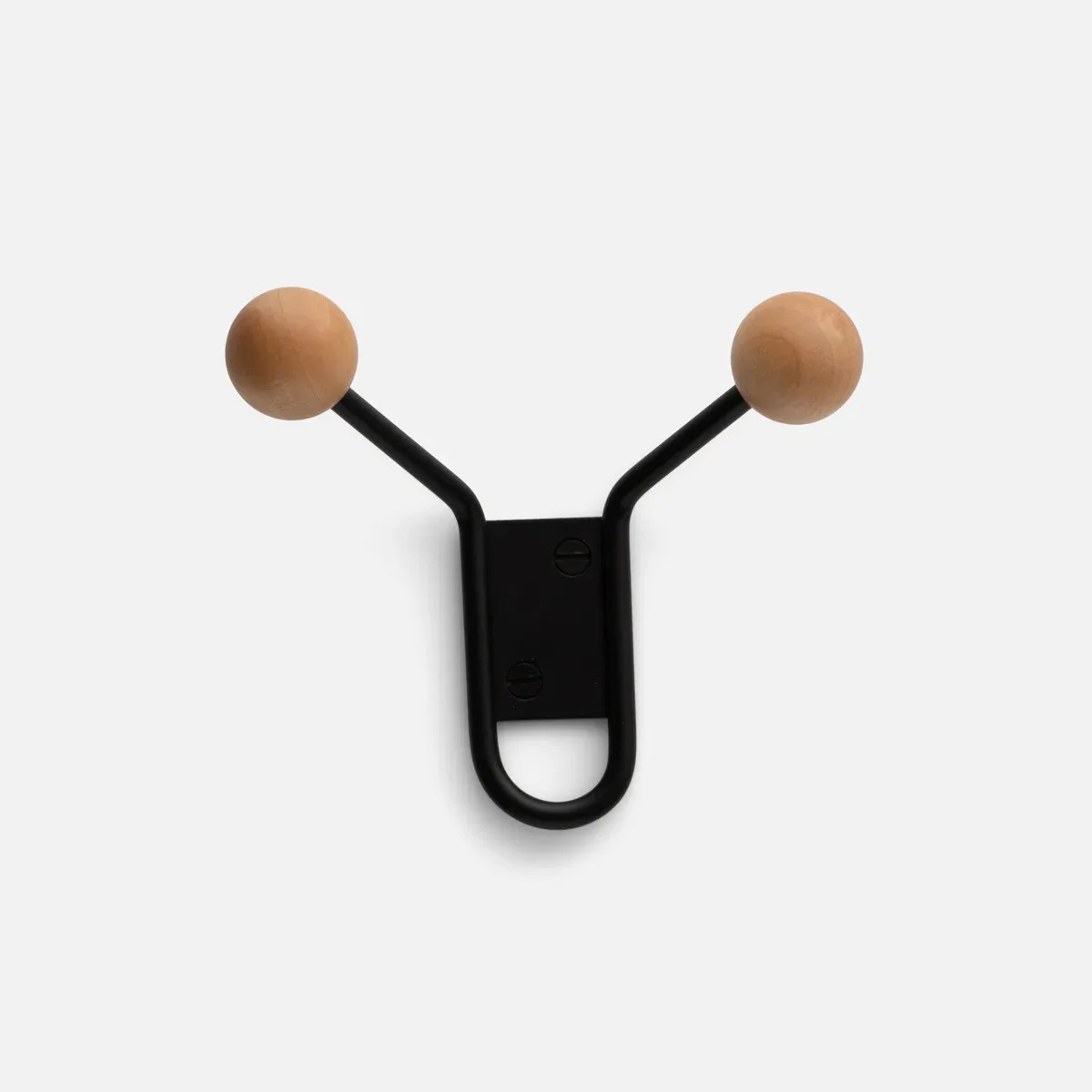 Black metal wall hook with two wooden round knobs on a white background.
