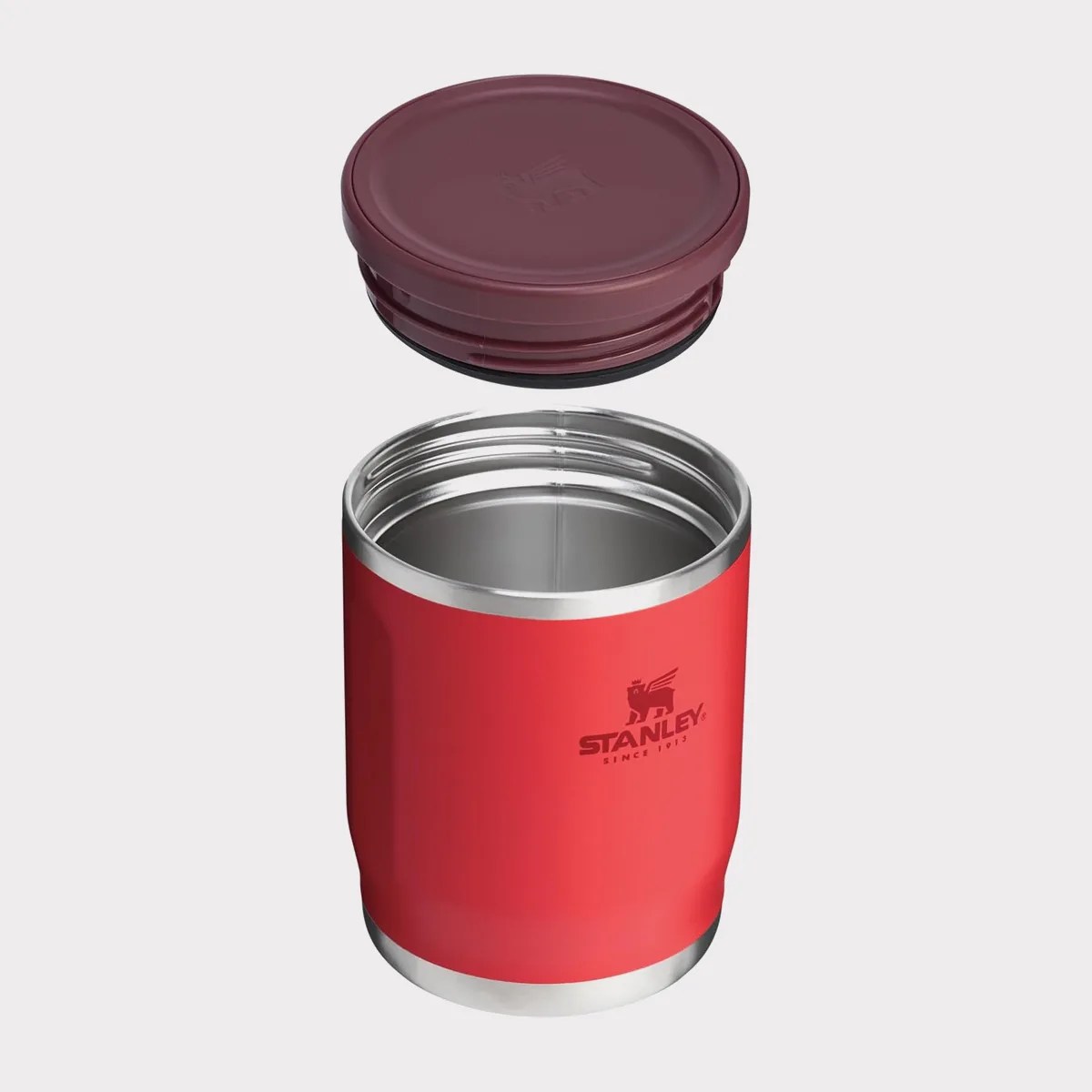 Red Stanley insulated food jar with a maroon screw-on lid floating above it.
