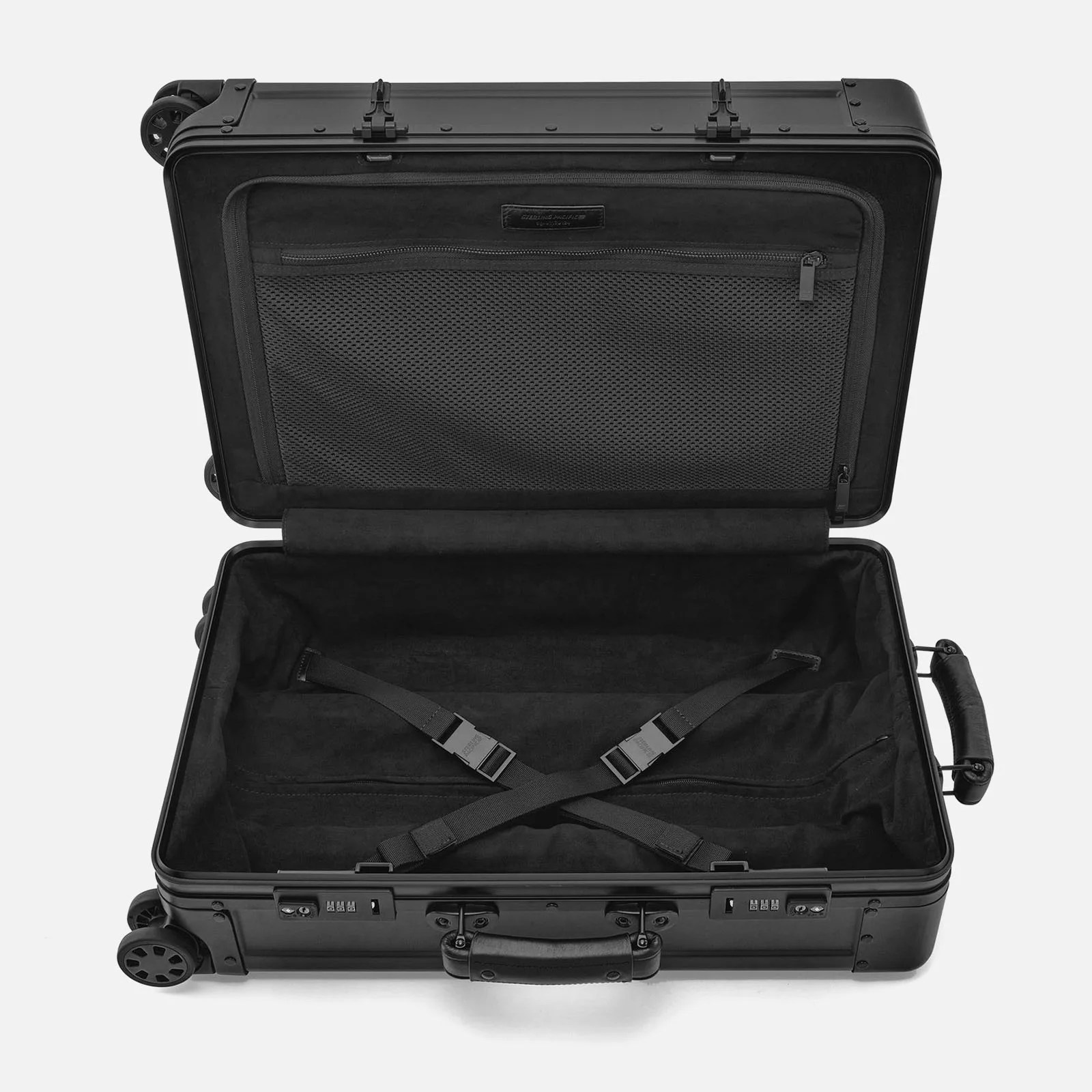 Sterling Pacific Cabin Travel Case 40L in black opened to reveal the suitcases zippered internal storage compartment on one side and x shaped strap system on the other.