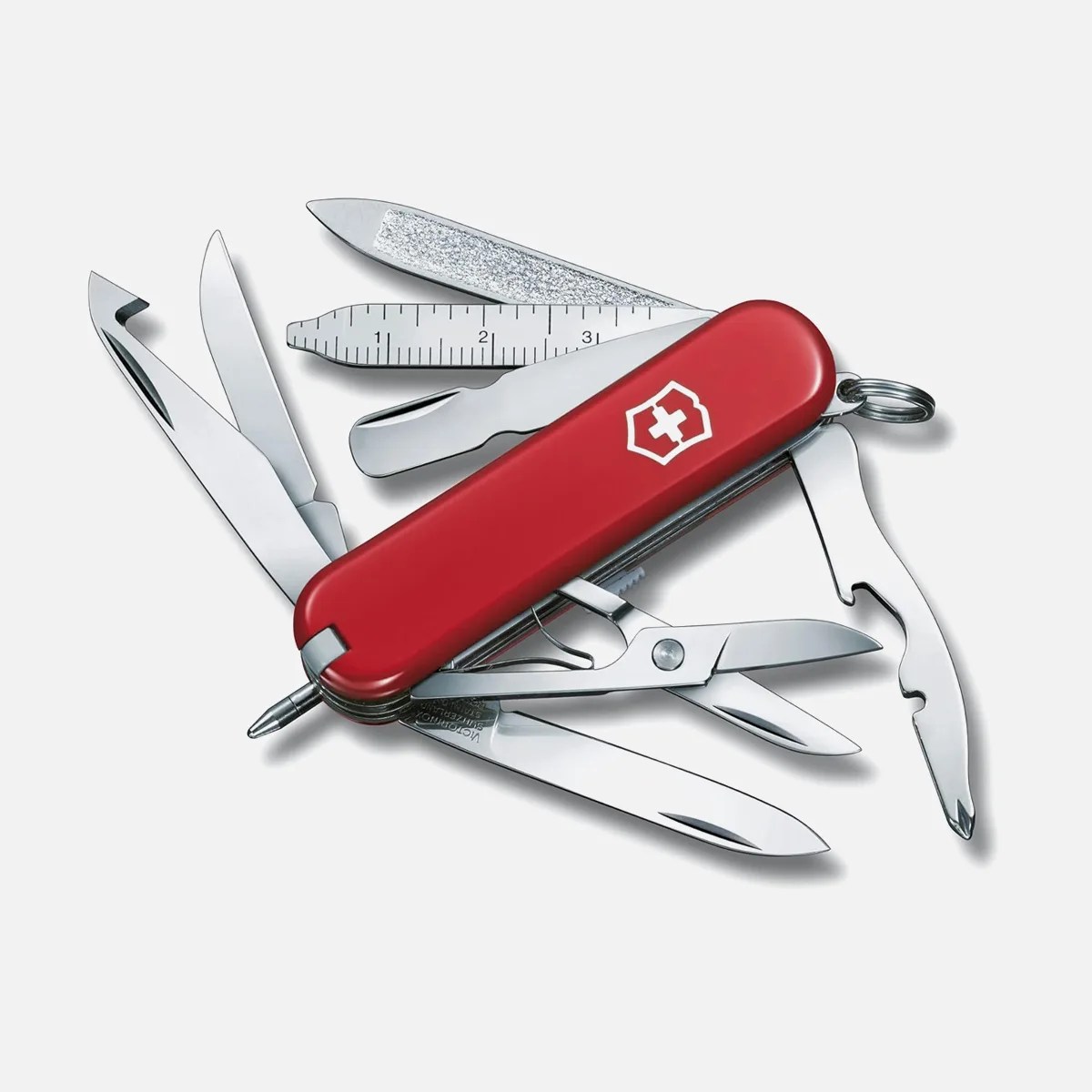Red Swiss Army knife with multiple open tools including blades, scissors, nail file, ruler, and bottle opener.