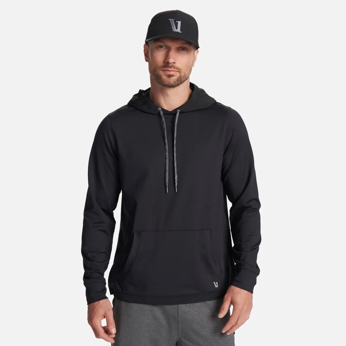Black long-sleeve hoodie with front pocket and gray drawstrings worn by a person.