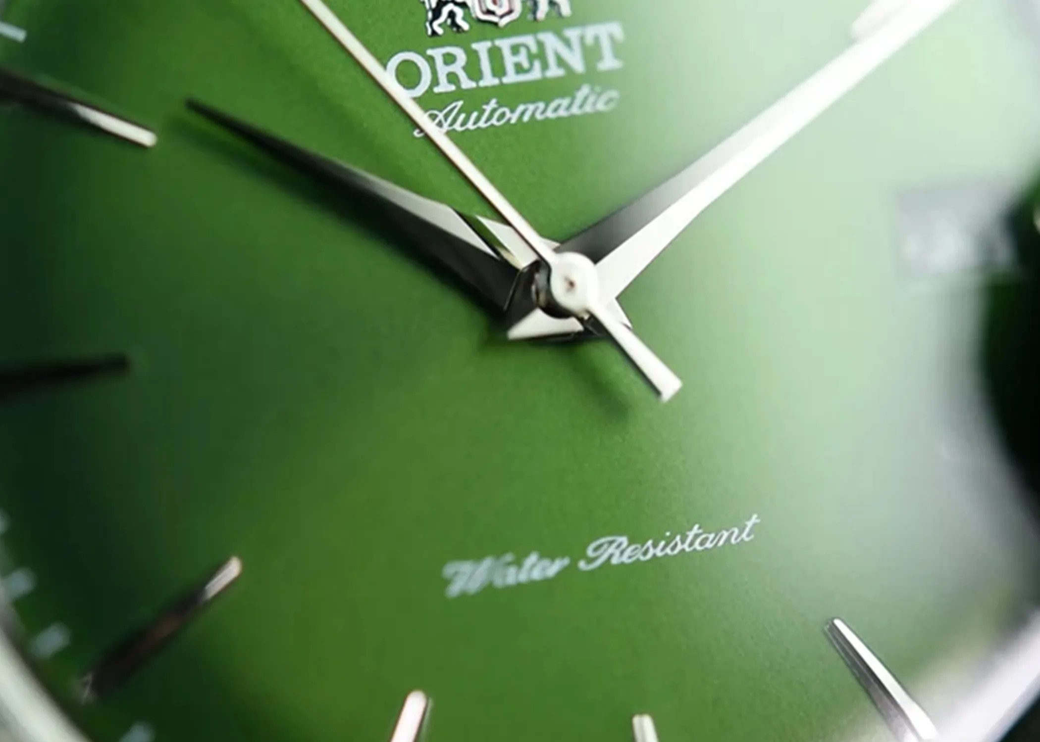 closeup of a green orient watch dial