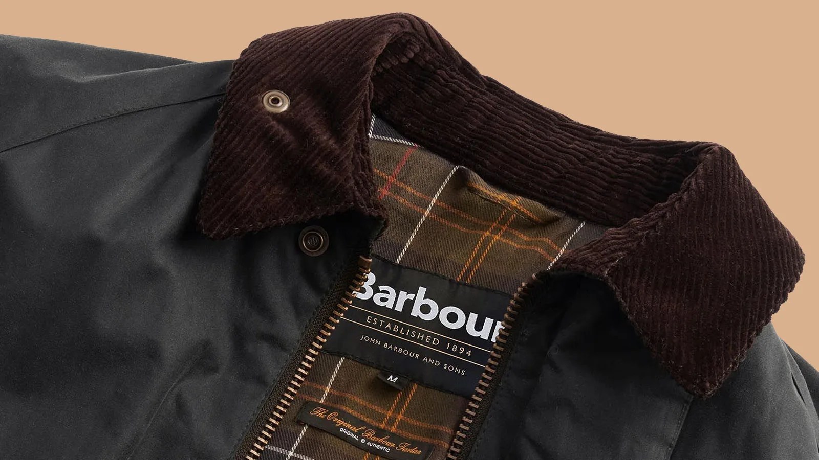 Barbour modified Beaufort waxed canvas jacket laid flat to show the Barbour brand label and collar