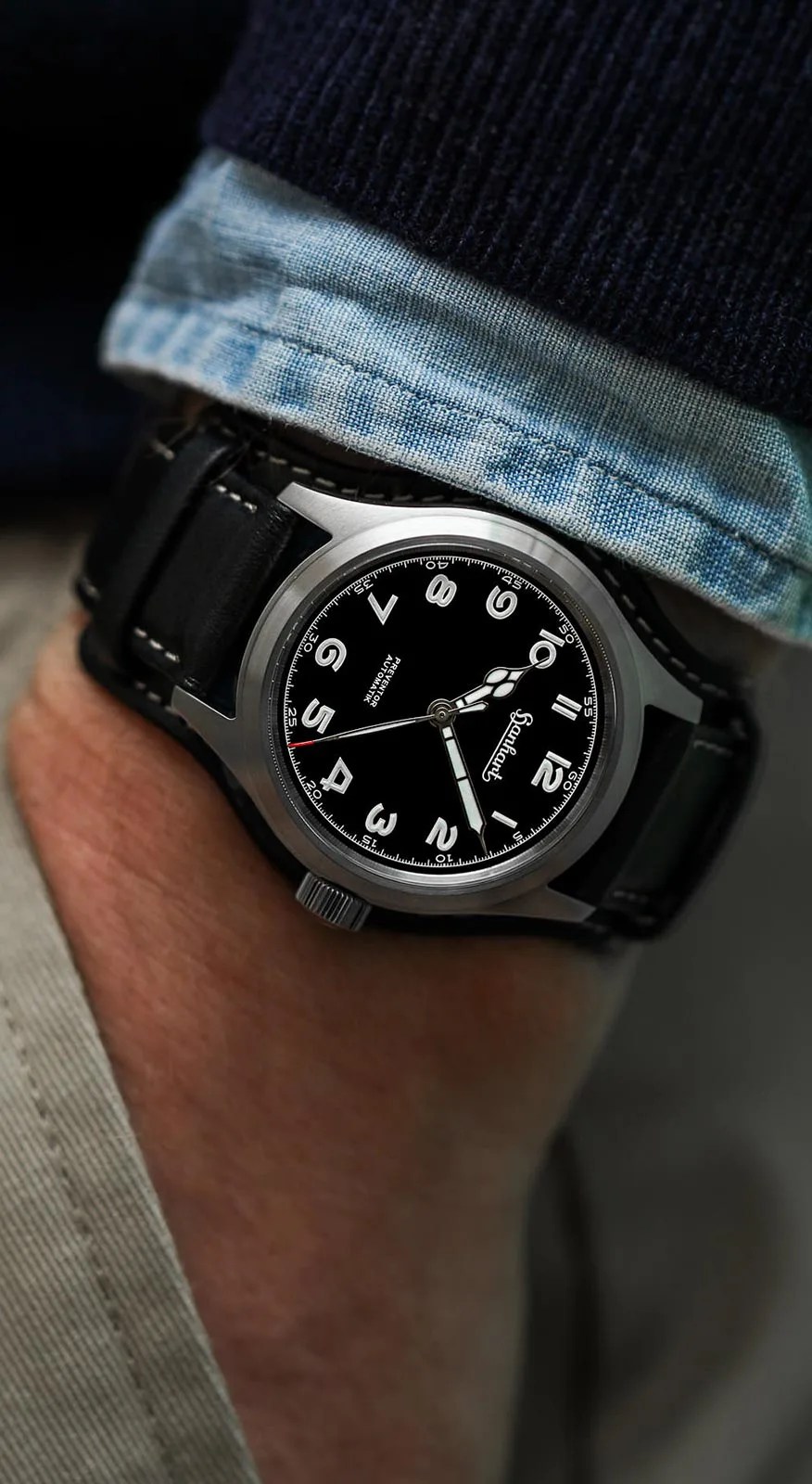 black hanhart watch on a mans wrist