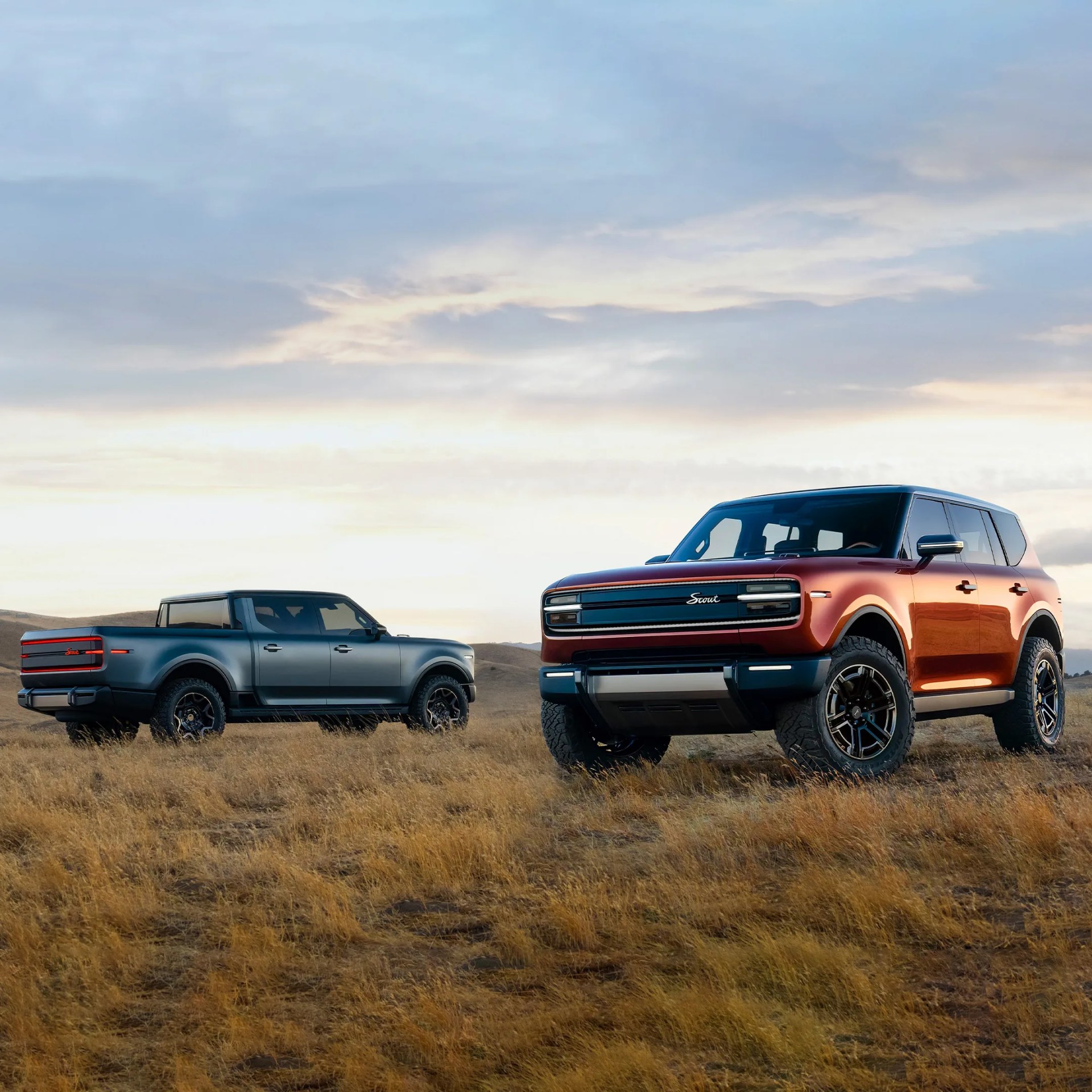 two scout trucks in a field