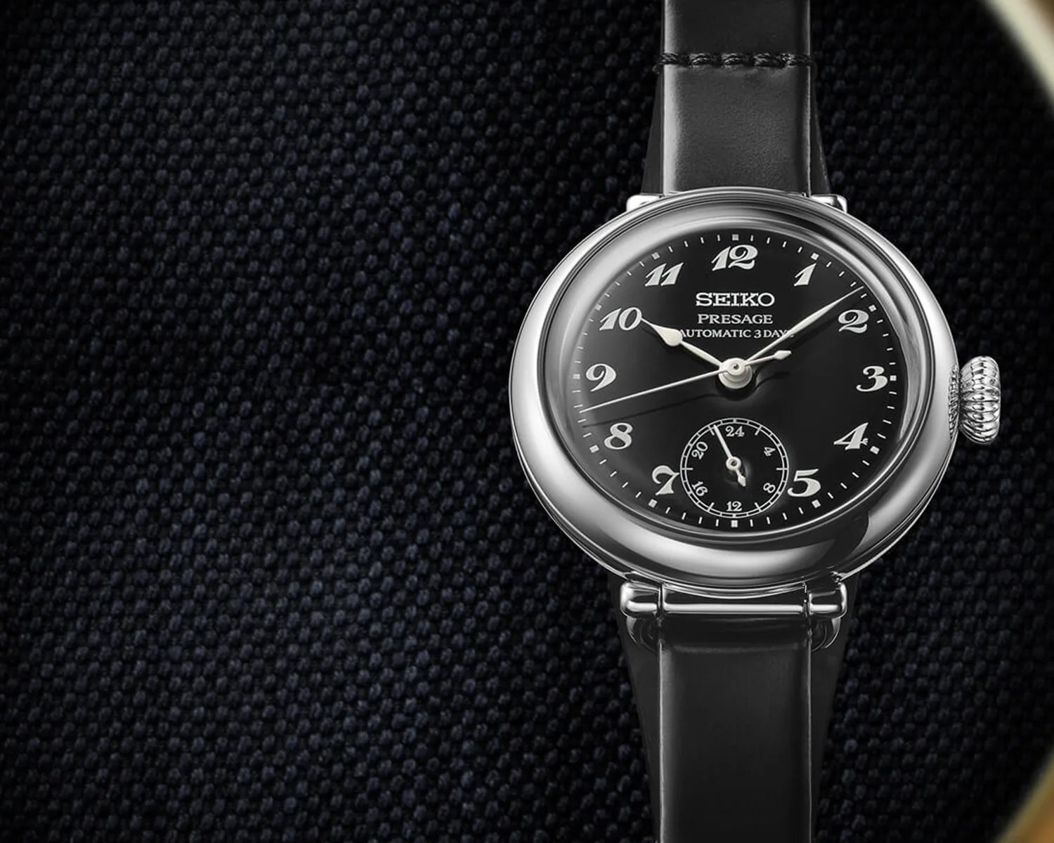 a seiko watch on some black cloth