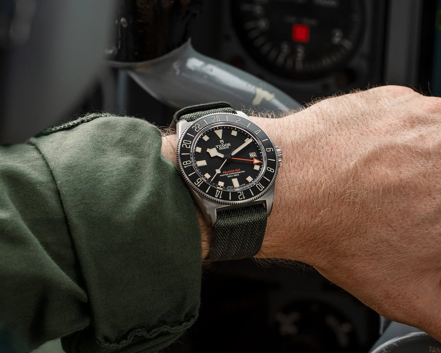 a tudor pelagos gmt tool watch on a pilots wrist