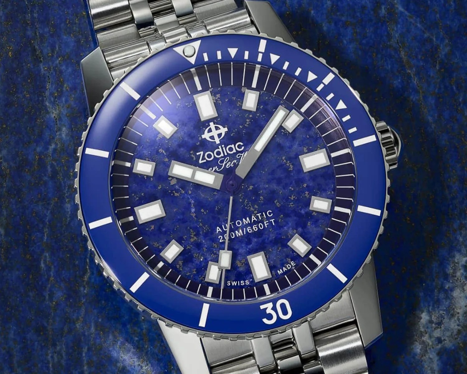 a closeup of a zodiac dive watch on a blue stone surface