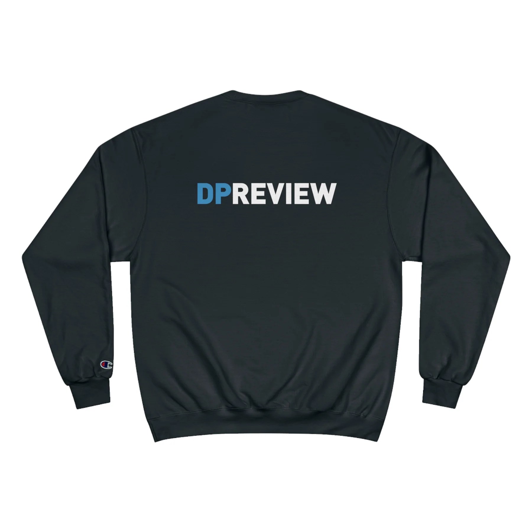 Black long-sleeve sweatshirt with the word "DPREVIEW" printed on the back in large letters, where "DP" is in blue and "REVIEW" is in white. The sweatshirt has ribbed cuffs and waistband, and a small Champion logo is visible on the left sleeve cuff.