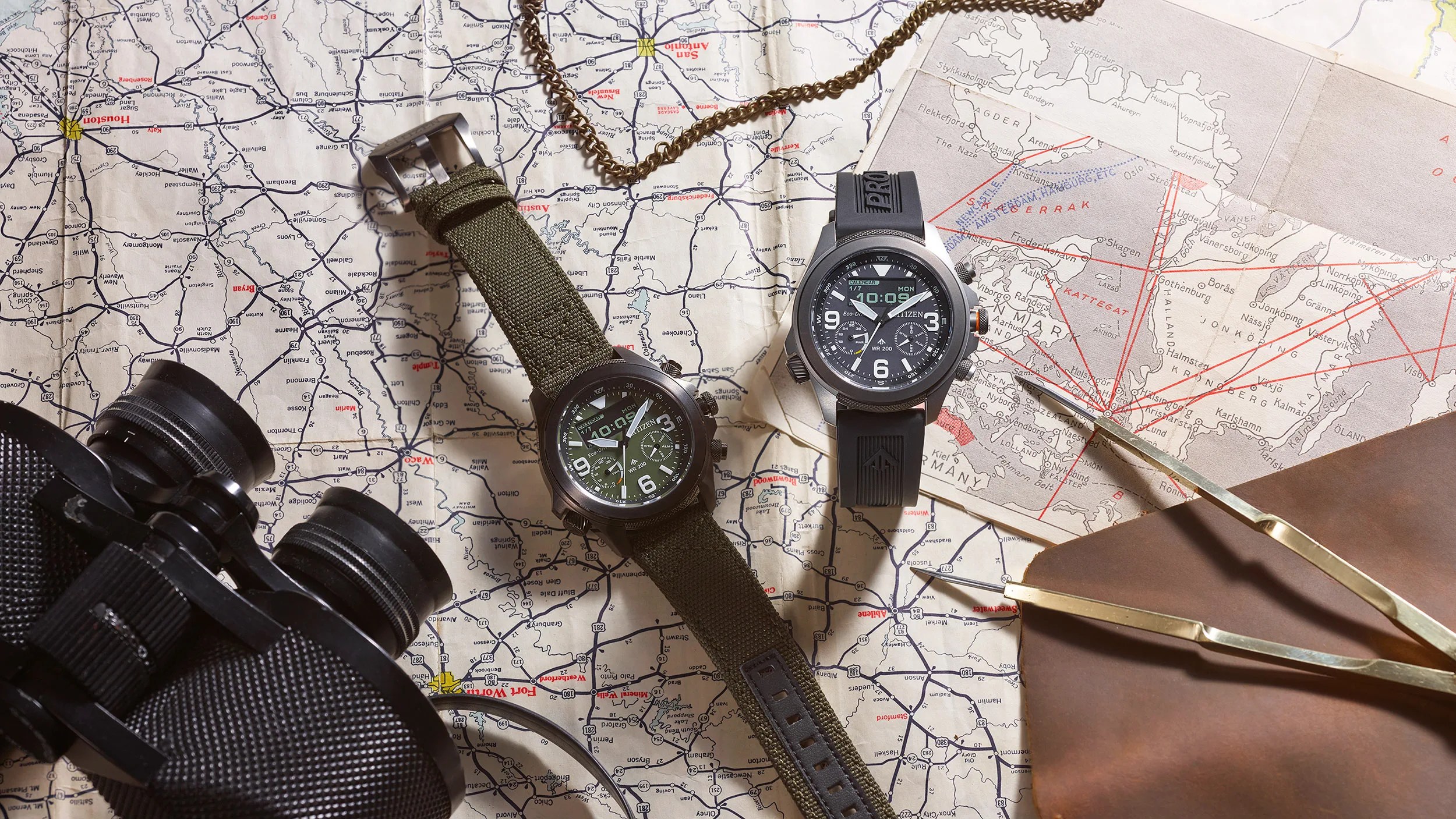citizen watches on table with map