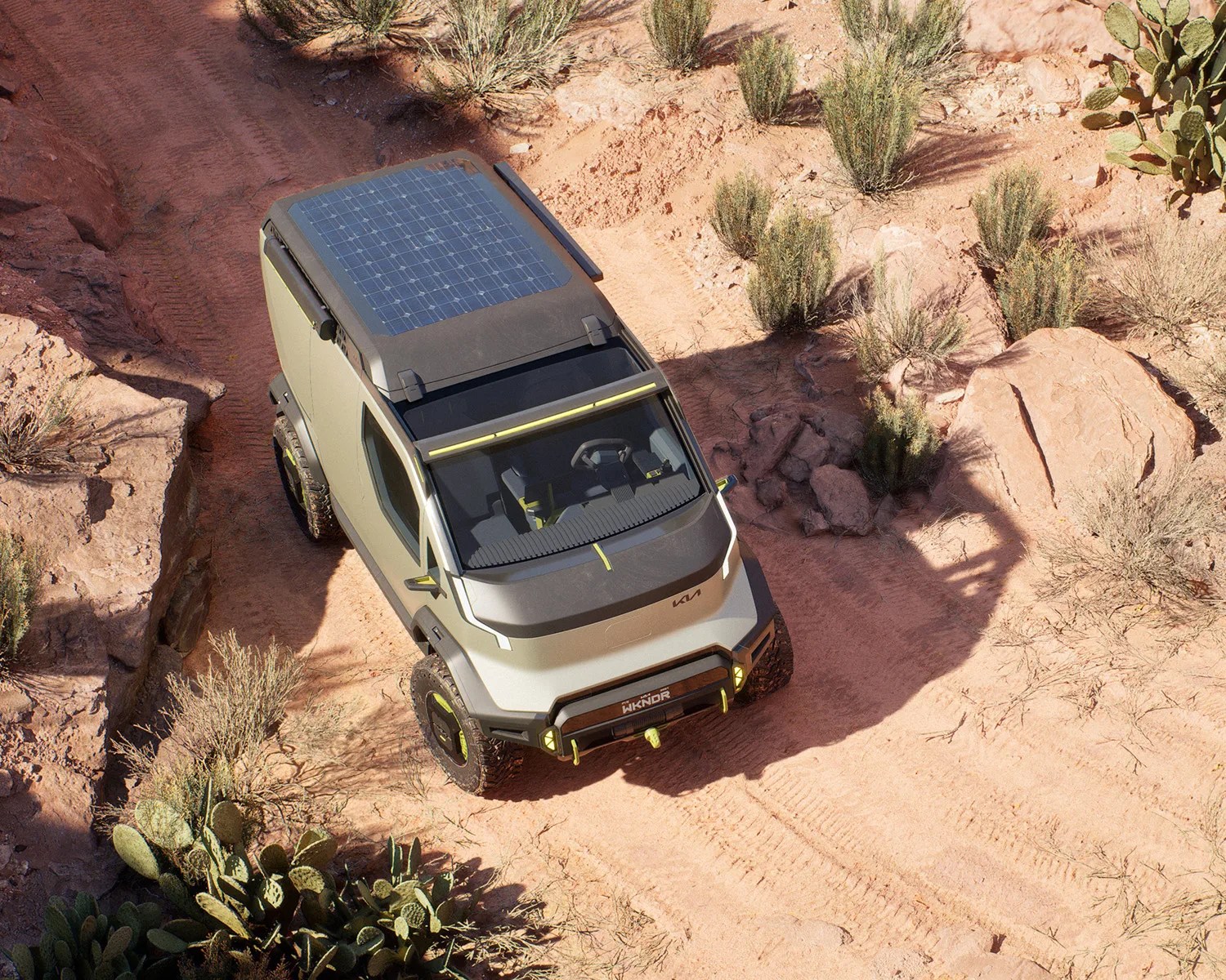 the kia pv5 wkndr ev camper van concept driving in the desert seen from above