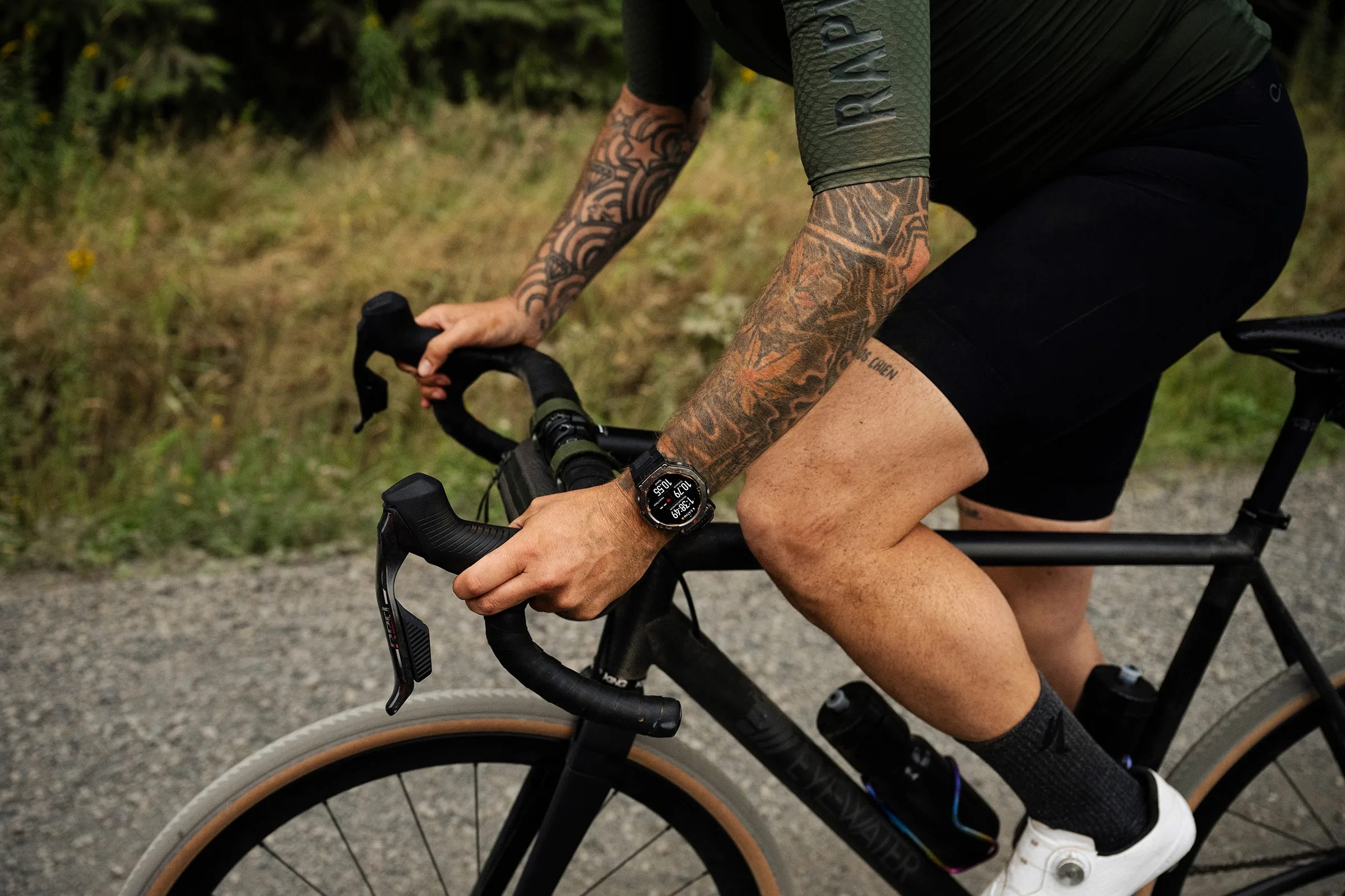 watch on wrist of man riding bike