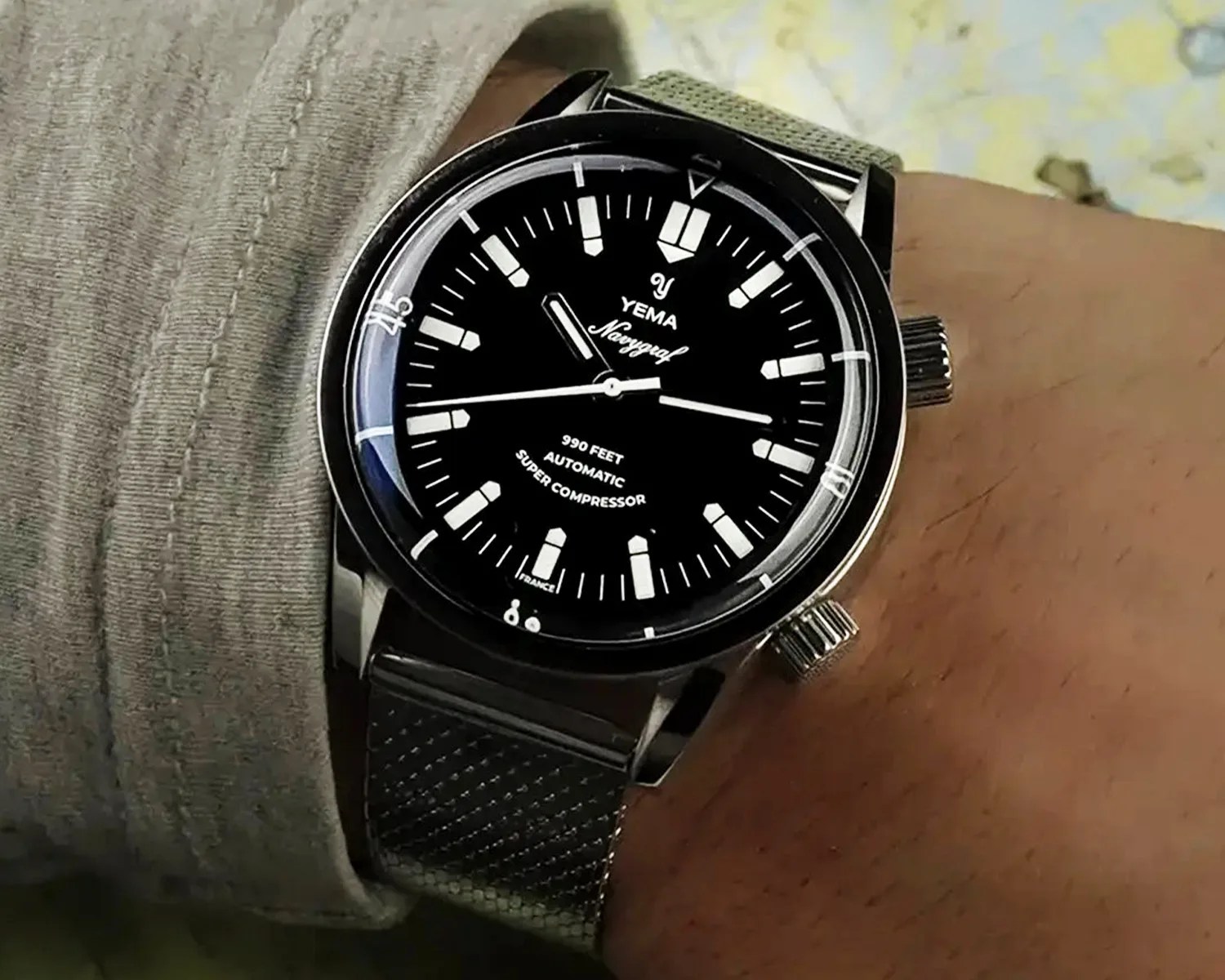 a yema super compressor dive watch on a mans wrist