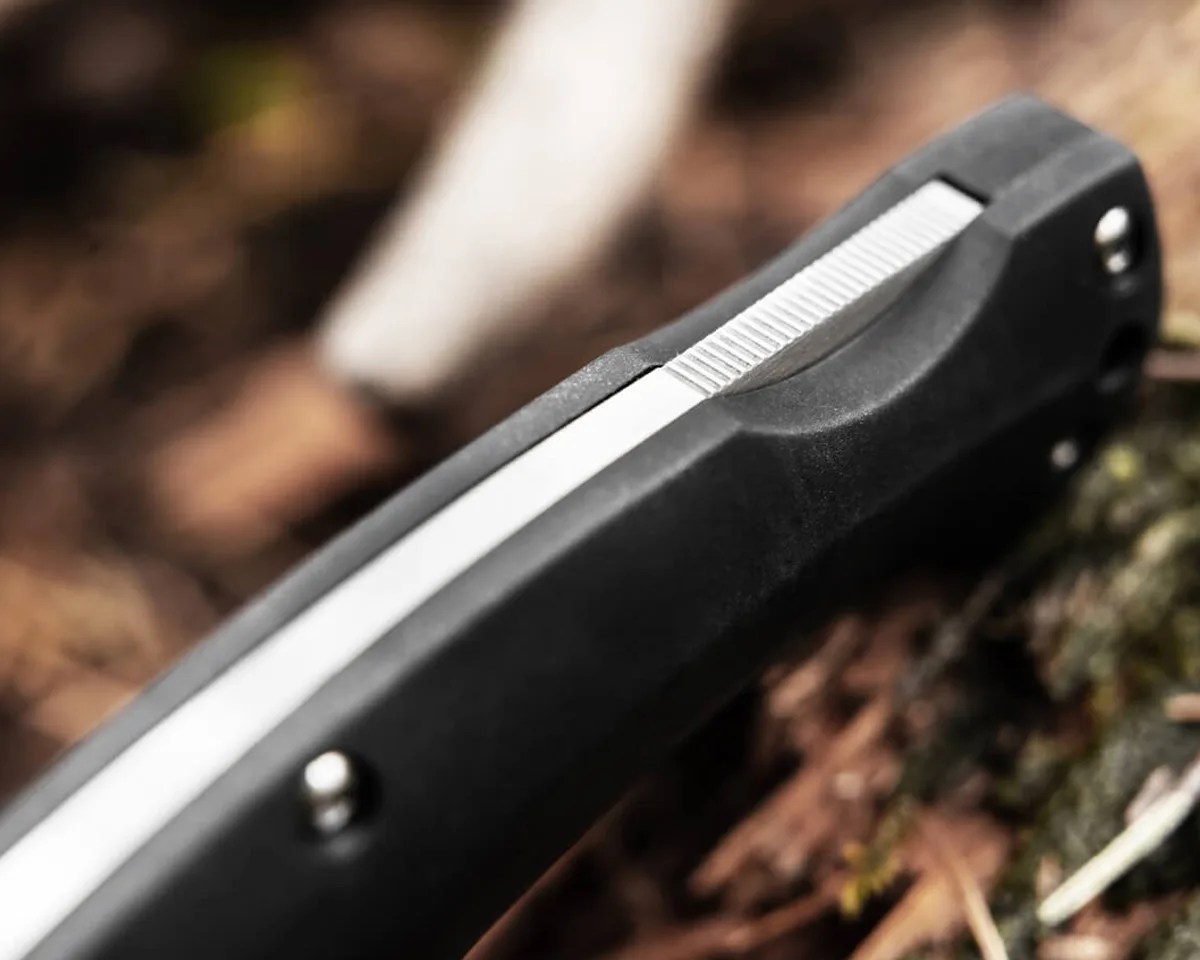 Close up of Boker Magnum Echidna knife back lock on forest floor