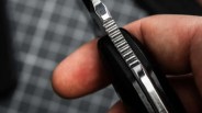 Böker Magnum Enki knife closeup of blade spine jimping held in hand