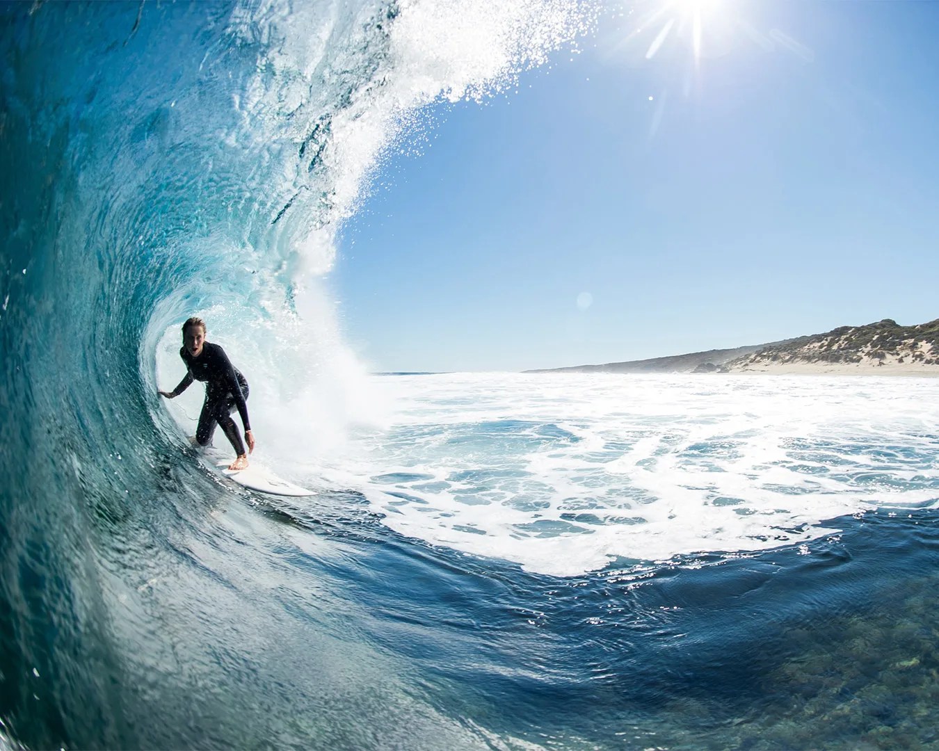 person surfing wearing Billabong Wetsuit