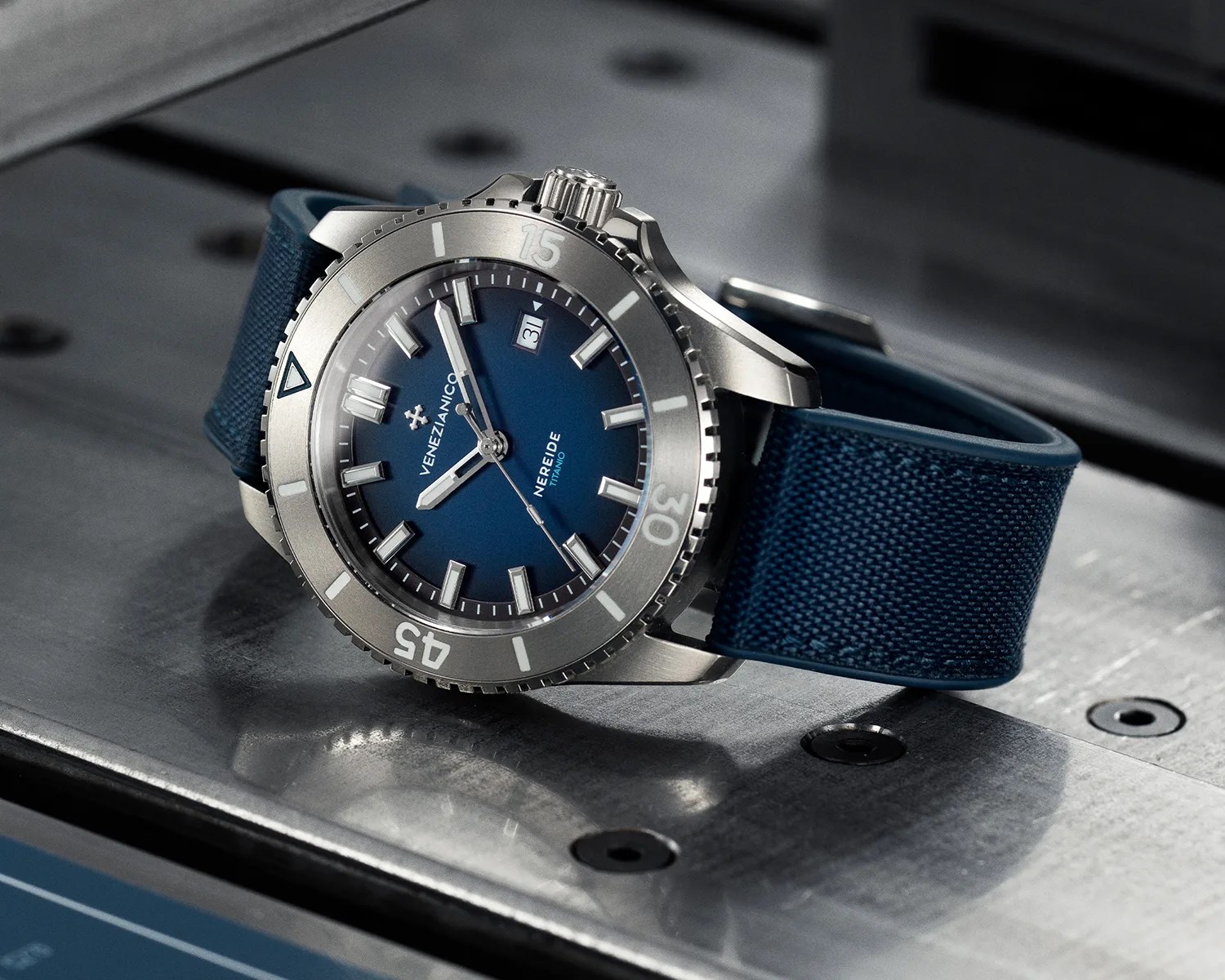 a venezianico titanium dive watch on a metal surface