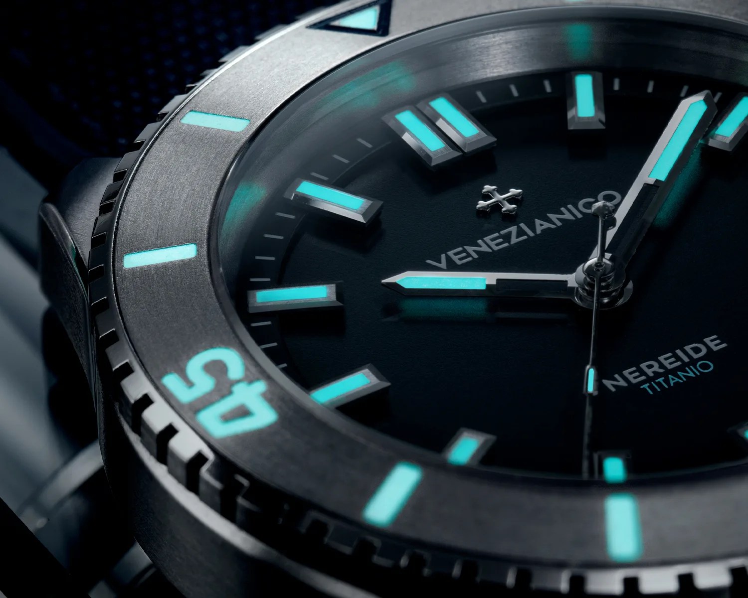 a closeup of a venezianico titanium dive watch bezel